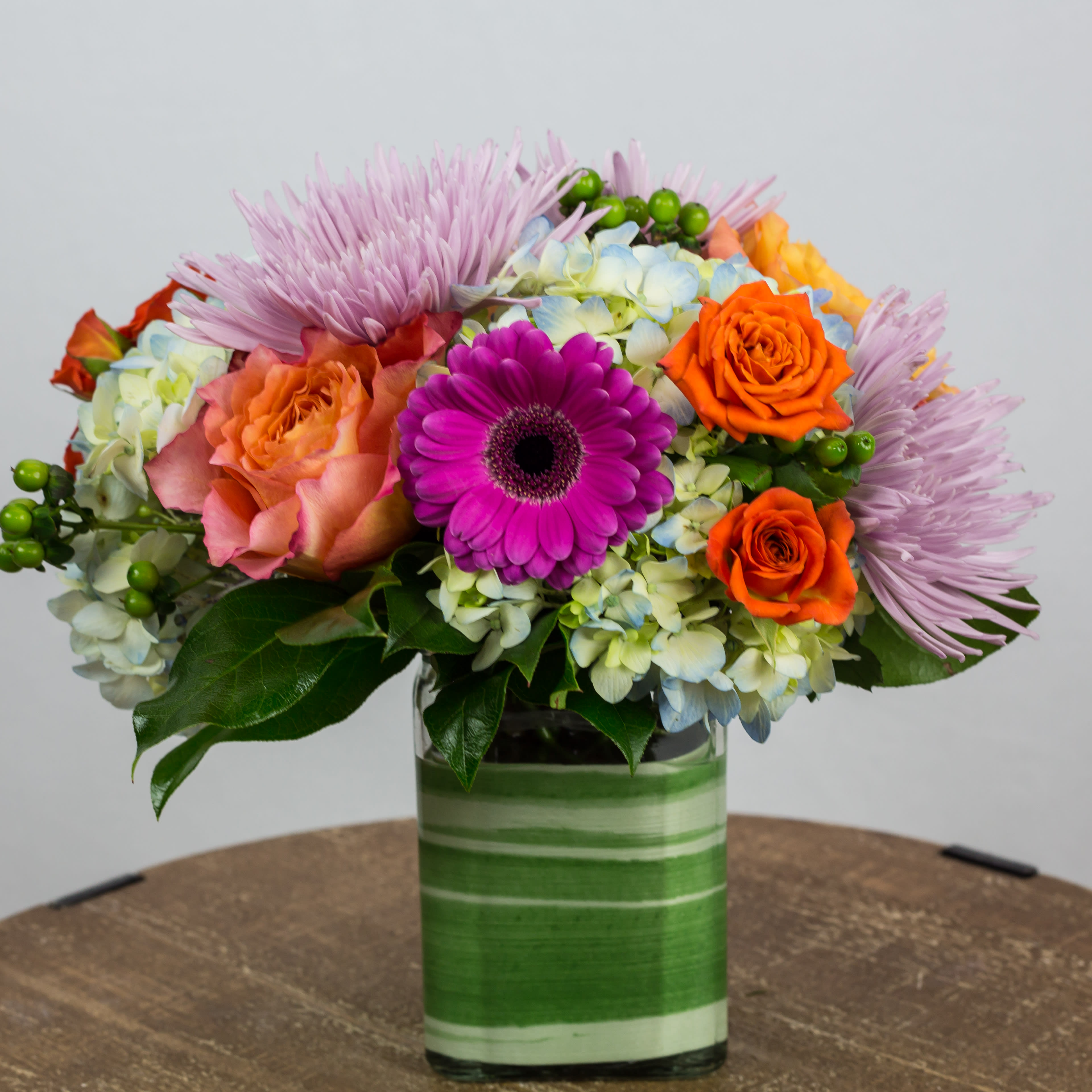 Colorful mixed bouquet in a striped glass vase