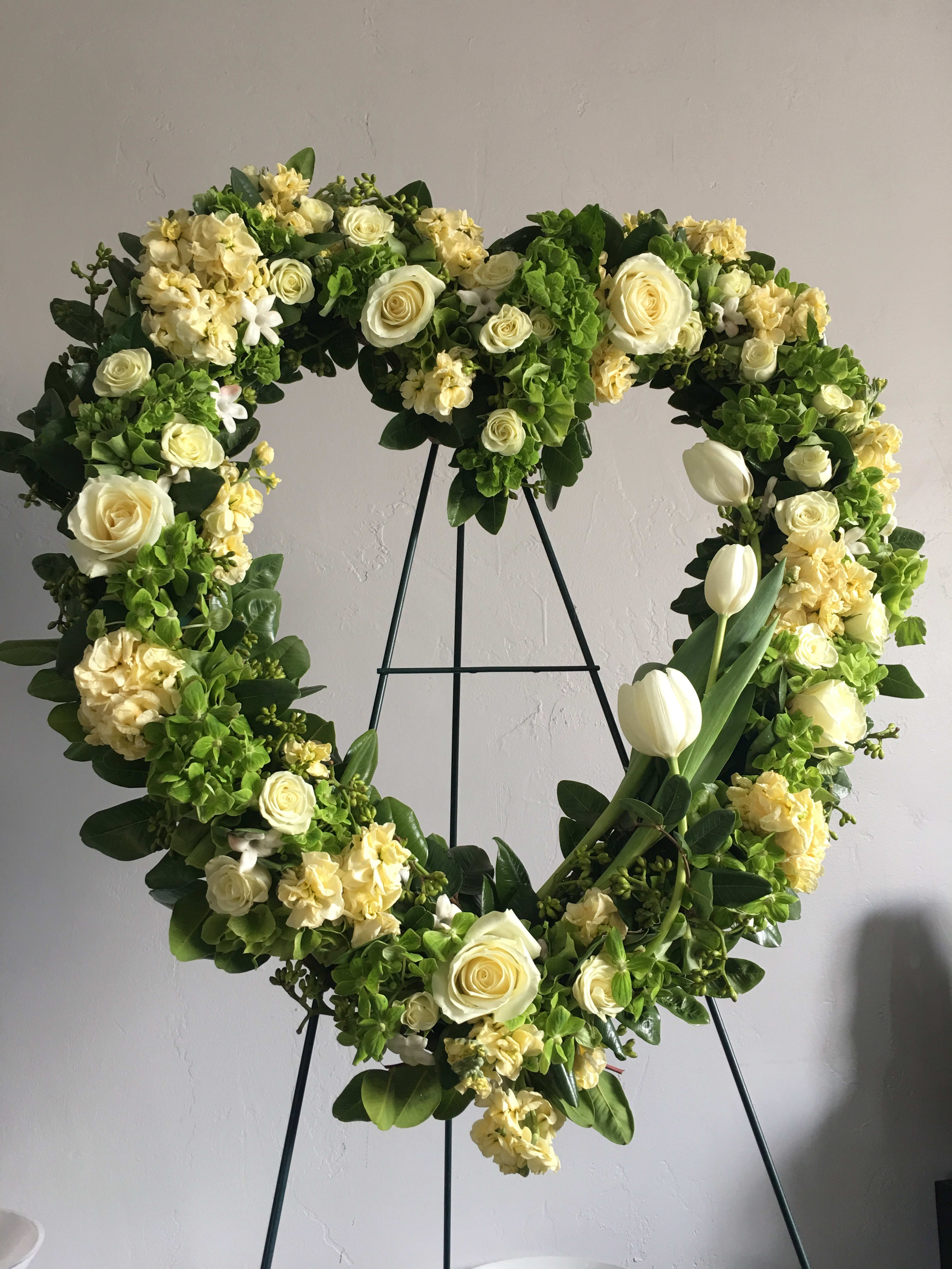 Divine Beauty - Soft yellows paired with green and white flowers beautifully designed in an open heart shape.