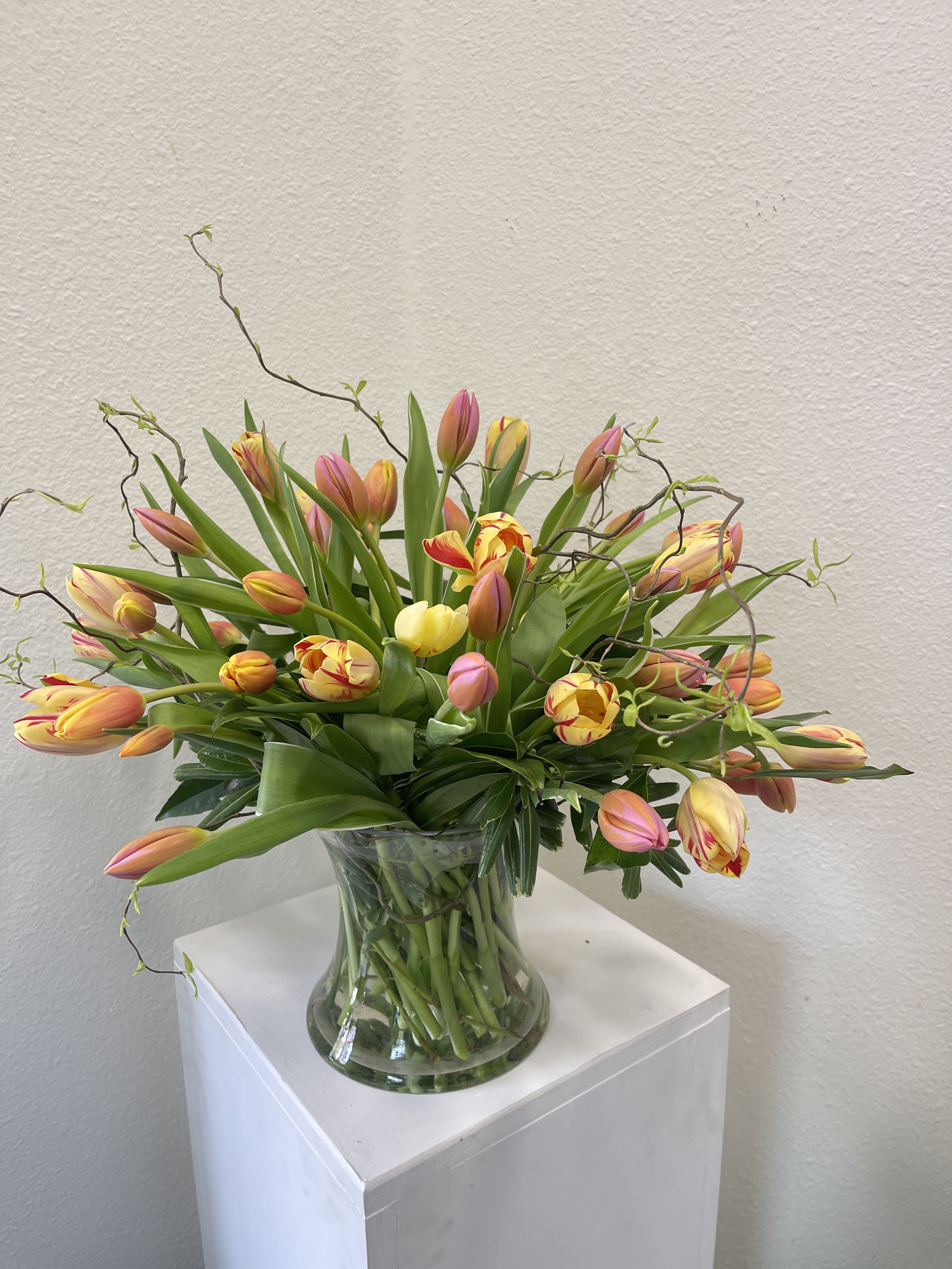 Fresh Tulips - An abundant collection of assorted tulips arranged in a clear glass vase. 