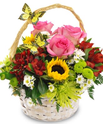 Basket of pink roses, sunflowers, and red blooms with butterfly decorations