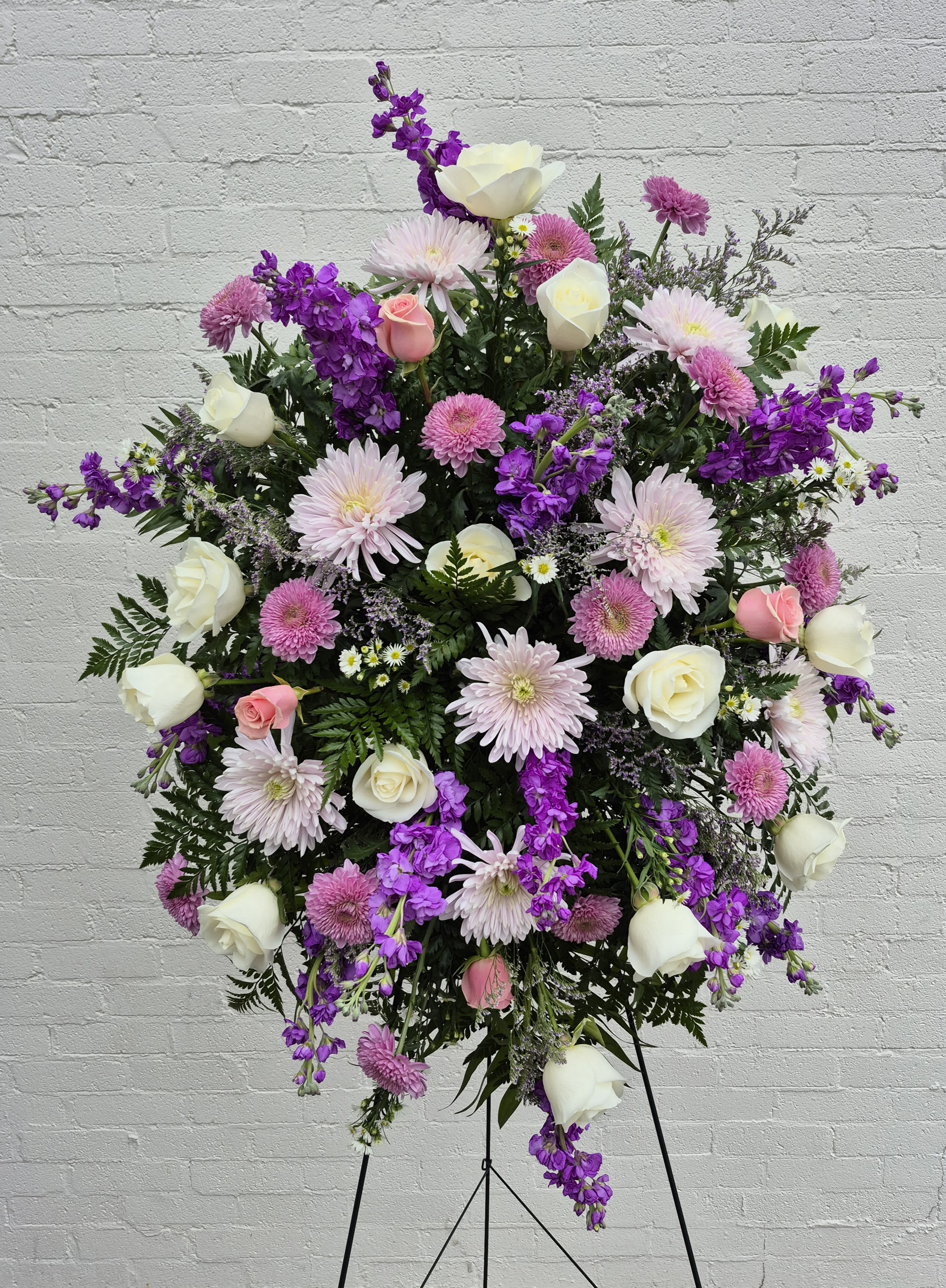 Lavender, White and Pink Standing Spray  - Our beautiful soft colors of lavender, white and pink standing spray. A funeral standing spray, presented on an easel, is a beautiful tribute to the deceased. Express your most heartfelt sympathies with a standing spray. 