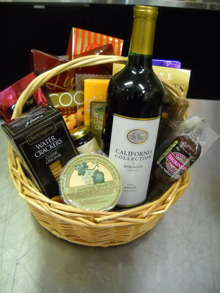 Gift basket with wine, crackers, cheese, and chocolates