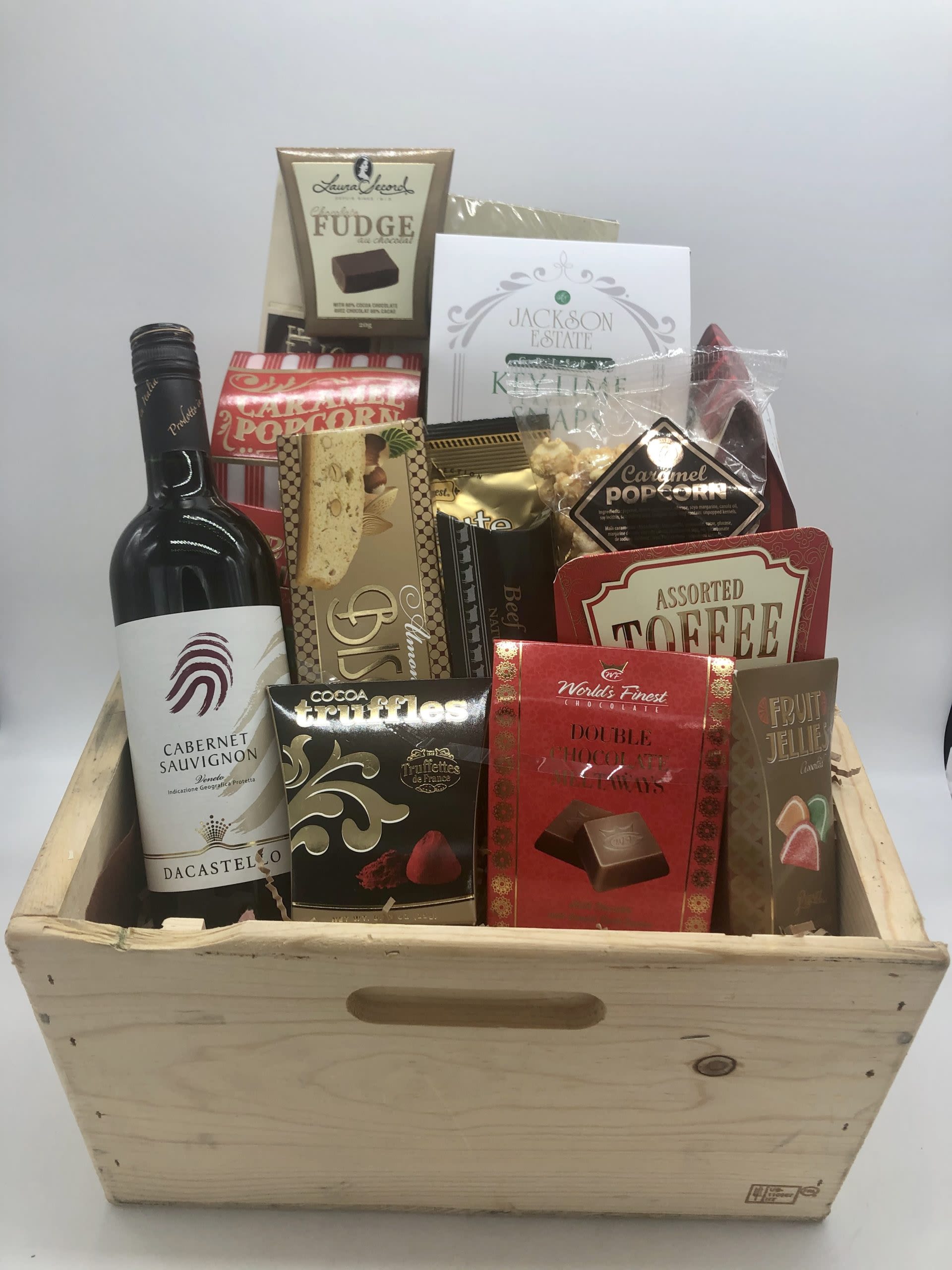 Gift basket with wine and assorted chocolates in a wooden crate