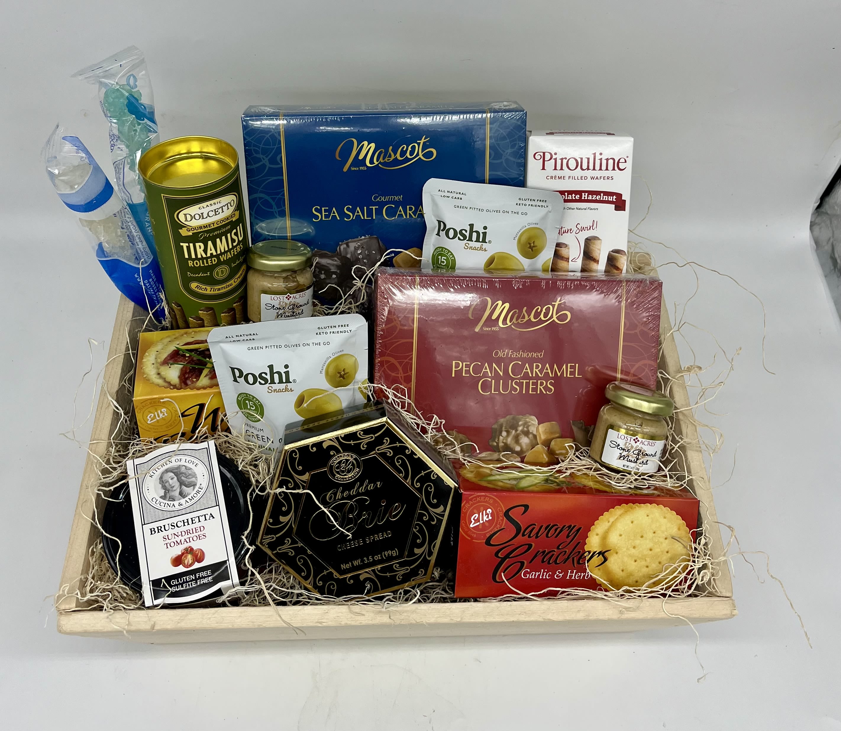 Gift basket with assorted snacks and candies in a wooden tray