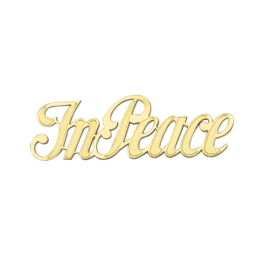 Gold script word "In Peace" on a white background