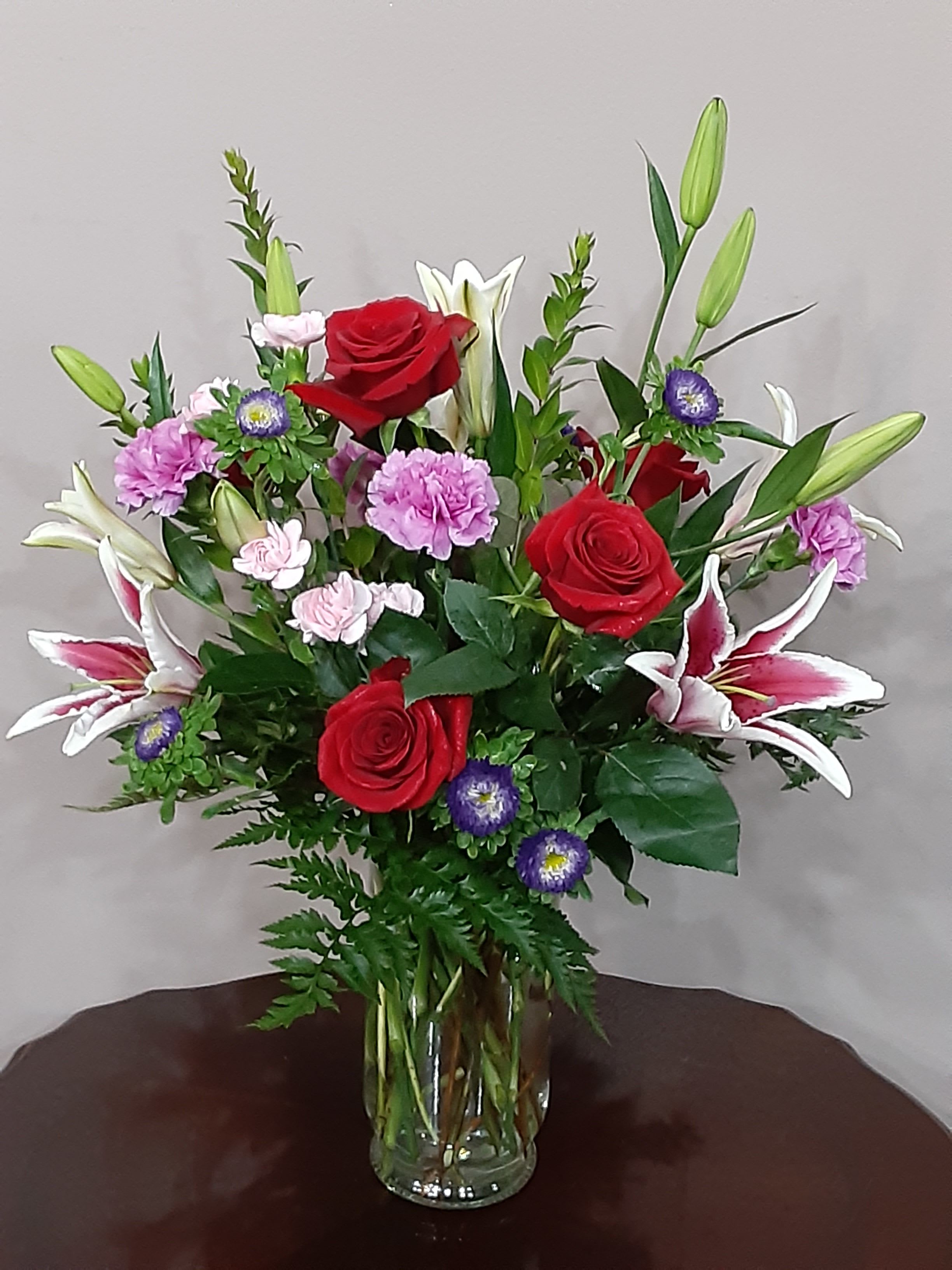 From the Garden - Does someone you know need a pick-me-up? Lift their spirits – and make the day special – by sending this charming display of blushing blossoms in shades of pink, red and purple. It’s the perfect all-occasion, fresh-from-the-garden bouquet.