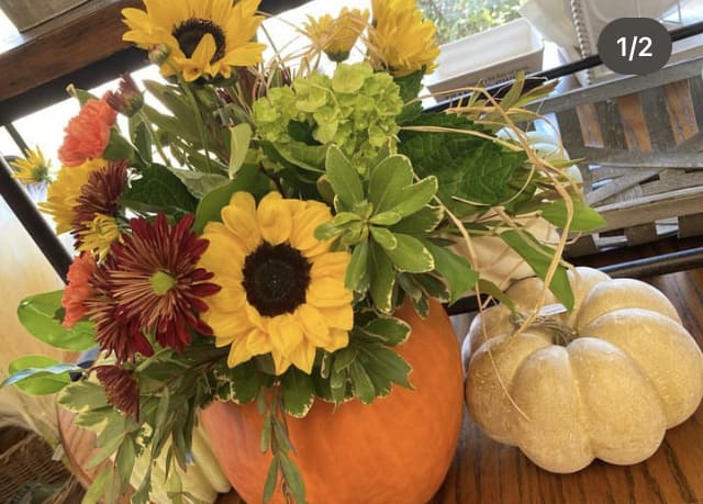 Sunflower and mixed fall bouquet arranged in a pumpkin vase