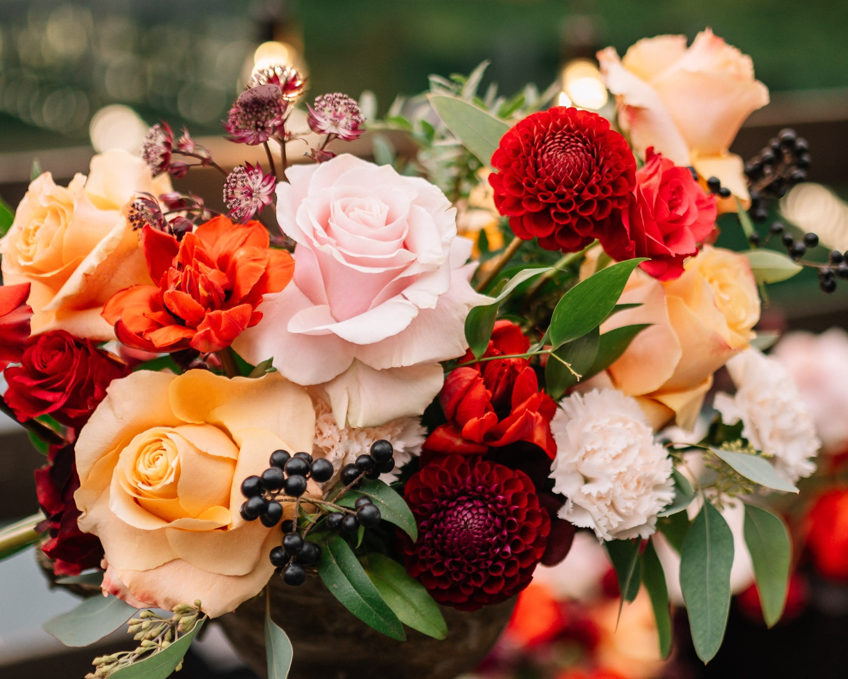 Designer's Choice - Autumnal - Floral arrangement in autumnal hues (i.e. red, orange, yellow, burgundy, fuschia, magenta, peach, etc.) presented in a ceramic vessel.   Each Designer's Choice vase arrangement will be one of a kind and consist of fresh, seasonal flowers. The arrangement depicted in the photo is just one example of our Designer's Choice Vase Arrangement. Actual arrangement may vary in terms of flower type, color scheme, and overall design depending on seasonal and local availability - but will be similar in size and include flowers of equal value.  Standard - 6" x 6" Vase Deluxe - 6.5" x 6.5" Vase Premium - 7"x 7" Vase