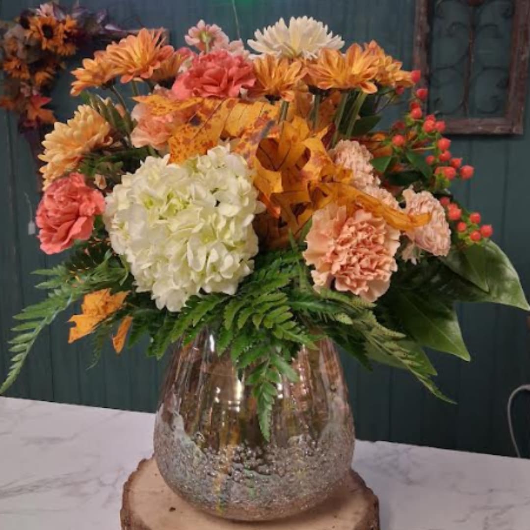 Autumn bouquet of mixed flowers in a glass vase