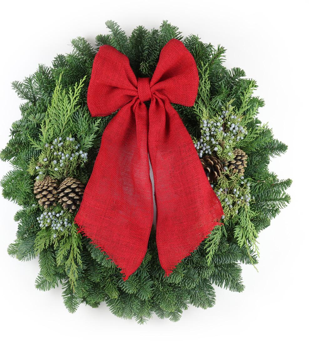 Evergreen wreath with pinecones, white berries, and a large red bow