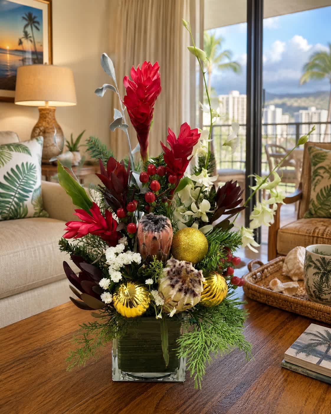 Tropical floral arrangement in a square glass vase with red and white blooms