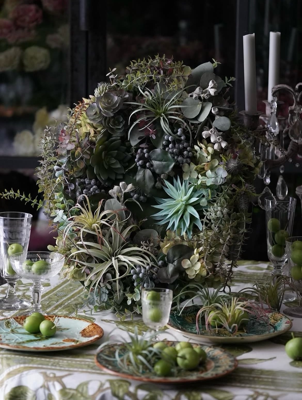 Large succulent centerpiece with air plants and eucalyptus on a table