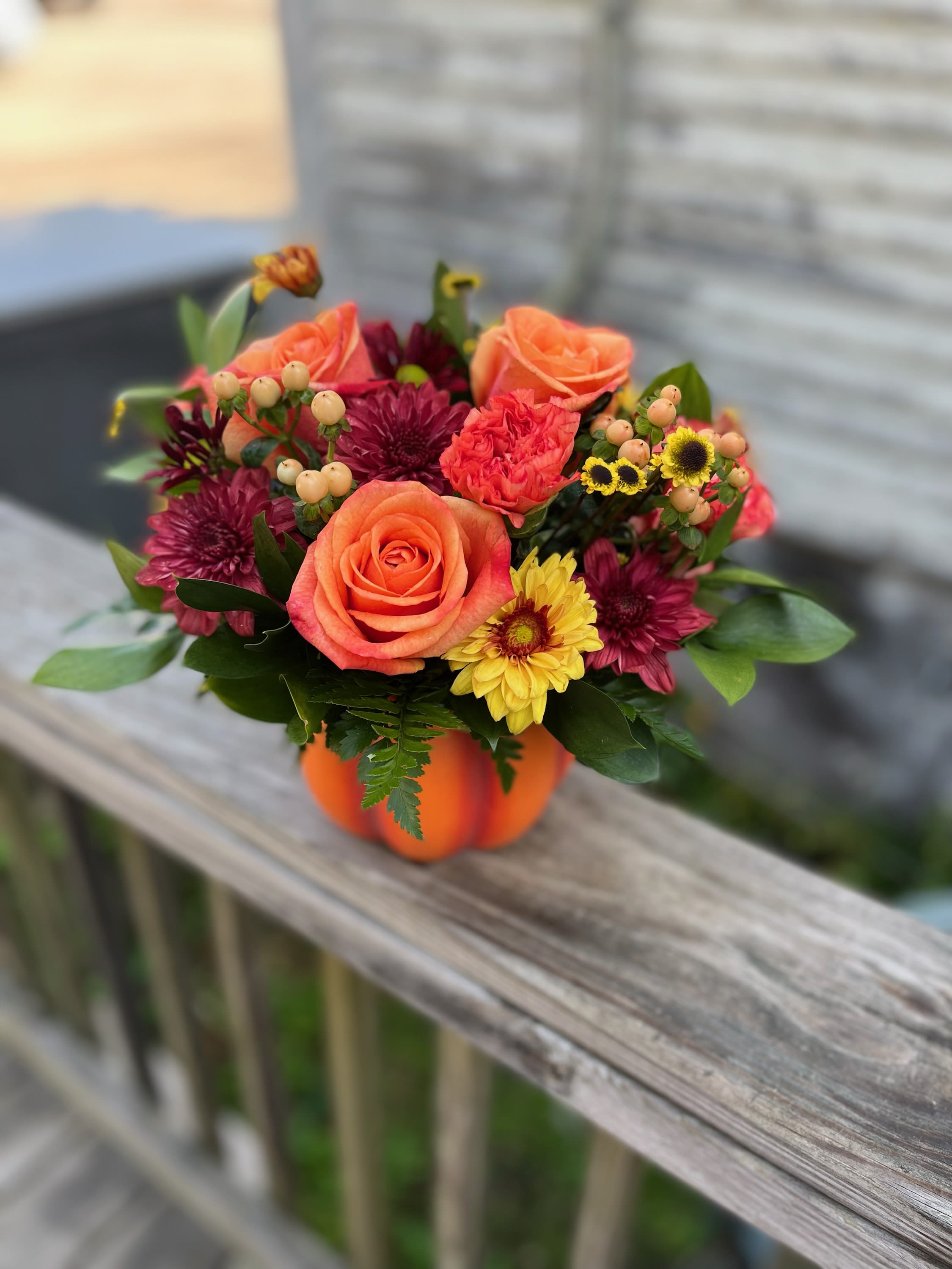  Fall Pumpkin 2 - Orange roses, yellow and burgandy chrysanthemums with peach hypericum berries arranged in a festive pumpkin container