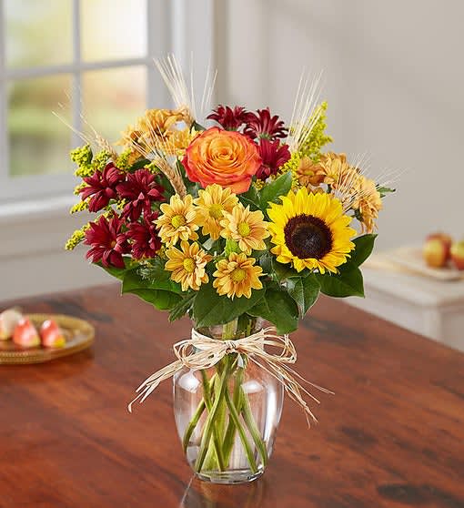 Fields Of Europe For Fall - All-around arrangement with autumn-colored roses, sunflowers, orange Asiatic lilies, red and autumn-colored daisy poms; accented with wheat, solidago and assorted greenery.
