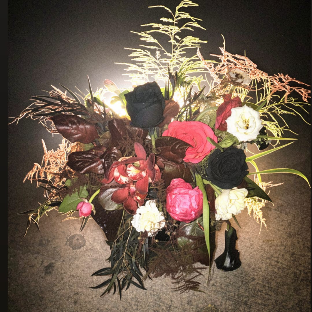 Mixed bouquet with black, pink, white, and burgundy flowers