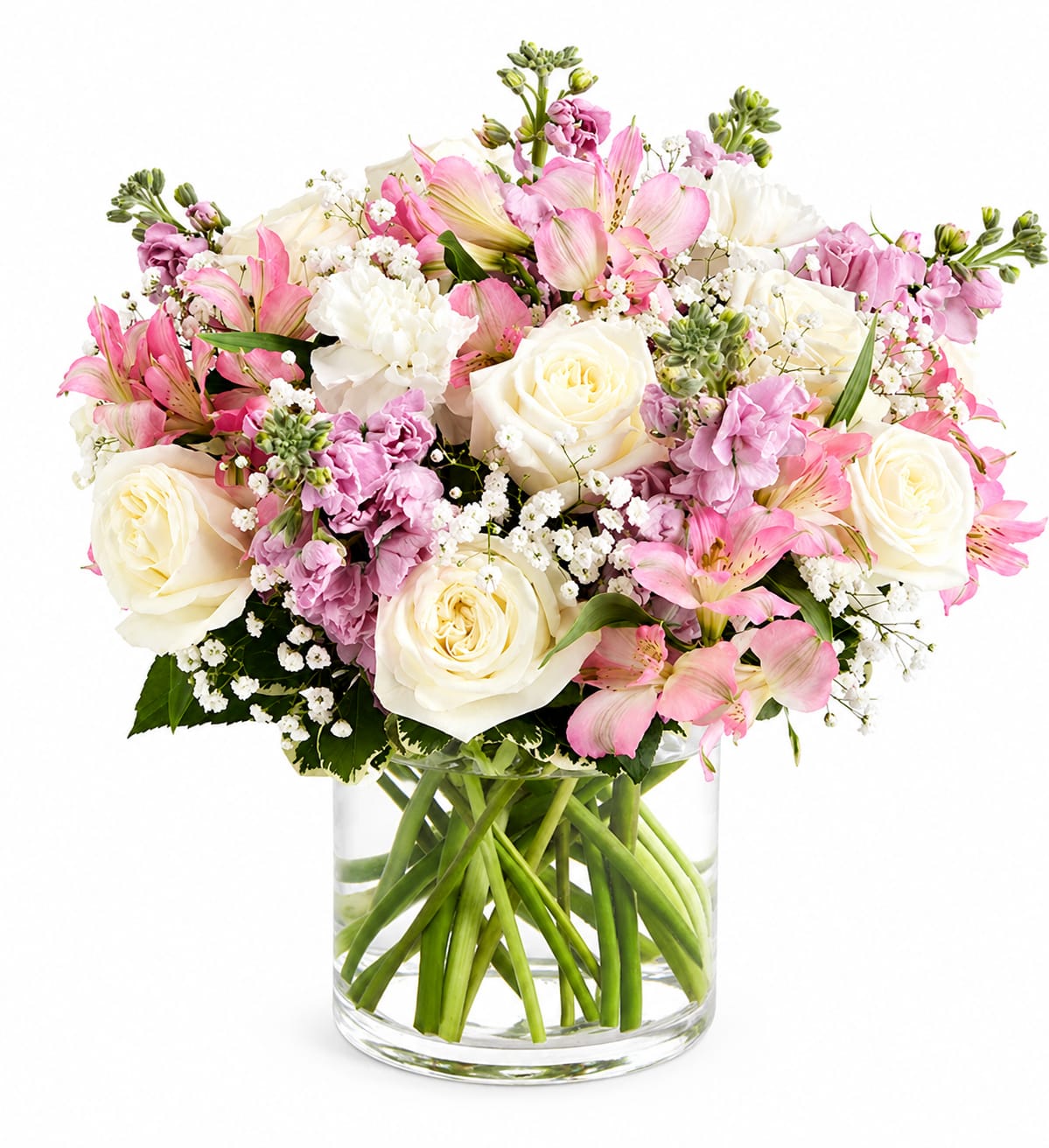 Blossom Arrangement - A soft, romantic mix of blush pinks, creamy whites, and spring-bright accents makes this flower arrangement an elegant choice for an anniversary or a cheerful birthday surprise. The rounded, all-around design in a clear glass vase shows off the visible stems for a clean, modern presentation that also reads as a thoughtful "just because" or sincere thank-you gift.  This arrangement blends white roses, pink alstroemeria, chrysanthemums, daisies, carnations and delicate filler blooms in a full, airy composition. Pale ivory and pink petals sit alongside pops of yellow, purple and green for a fresh, seasonal palette; ruffled carnations and layered alstroemeria add texture while the roses provide a classic focal point. The clear glass vase keeps the look light and contemporary and lets the arrangement be displayed from every angle.  Perfect for someone who enjoys soft, romantic florals with a modern touch - she'll feel genuinely celebrated whether it's a springtime birthday, an anniversary, or simply to say thanks. The arrangement is designed to be enjoyed right away: keep water fresh, recut stems occasionally, and place away from direct heat to extend vase life.