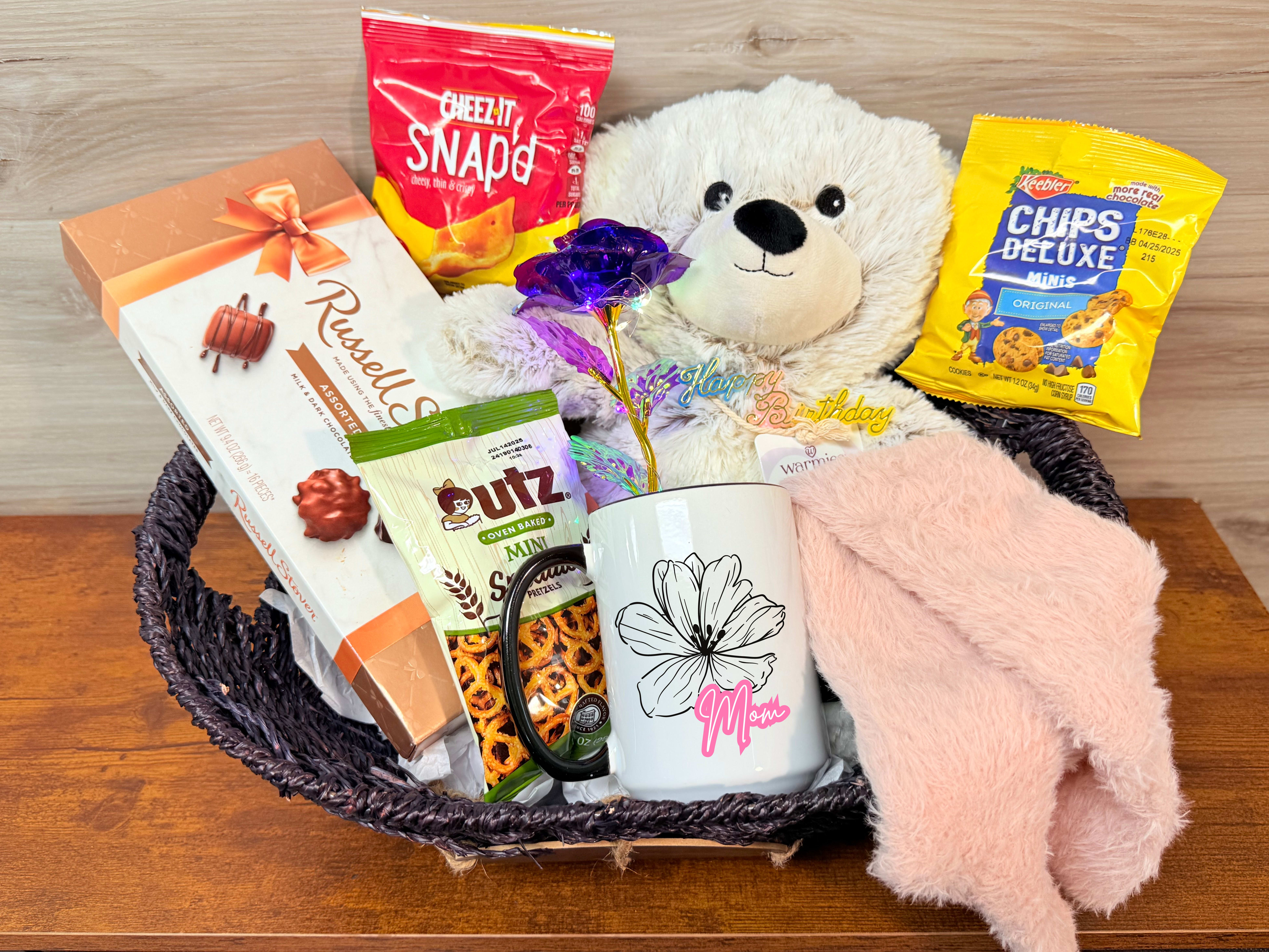 Happy Birthday mom gift basket - Show your mom you love her on her birthday with this basket! Including: - A full sized warmies bear -Fuzzy socks - Box of chocolates - Light up rose - Mom mug - 3 other snacks (varies) -A reusable basket.