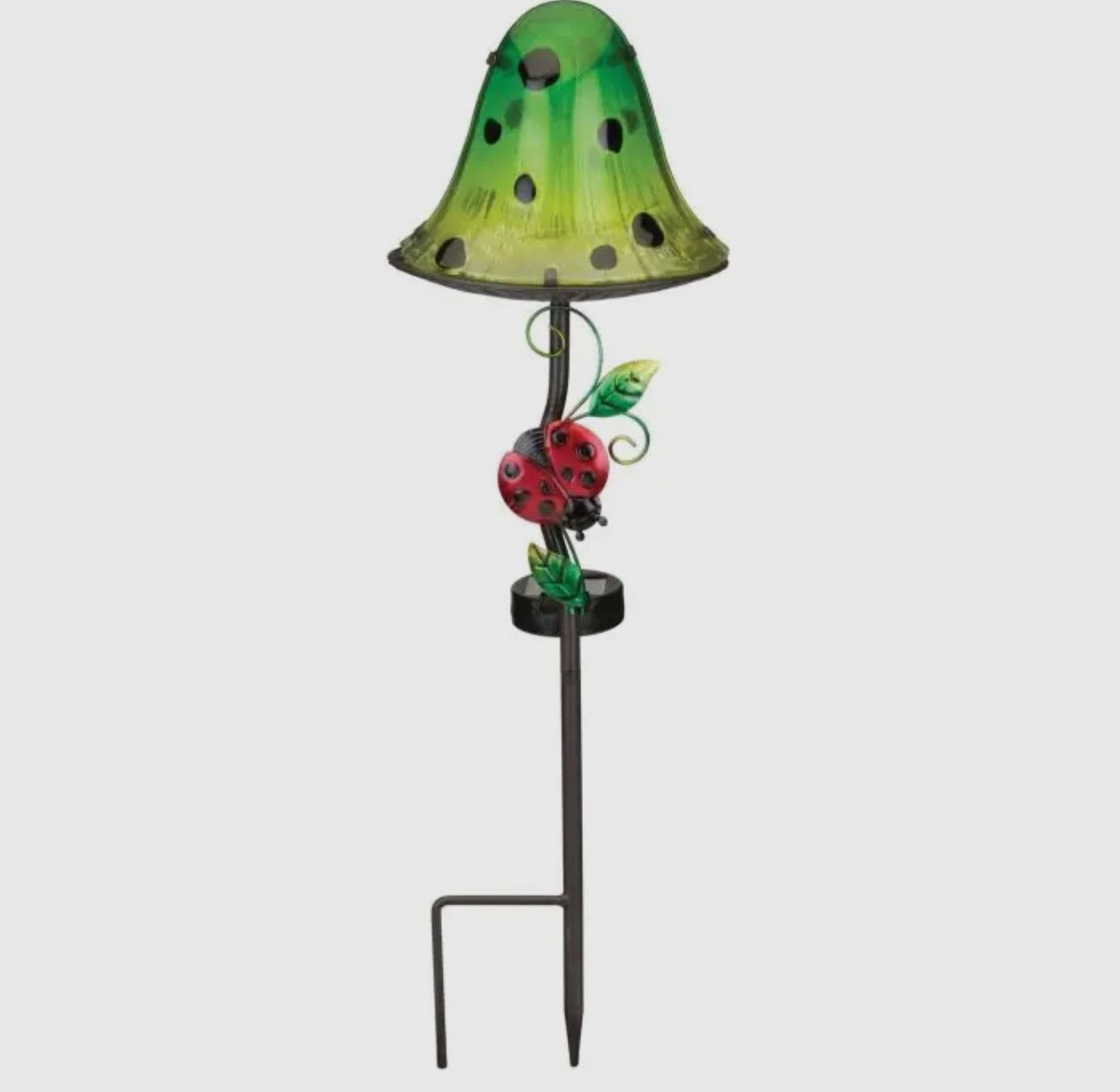 Green garden stake lamp with a ladybug decoration