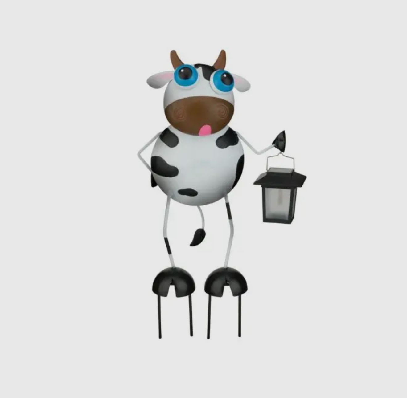 A cartoon cow figurine holding a lantern.
