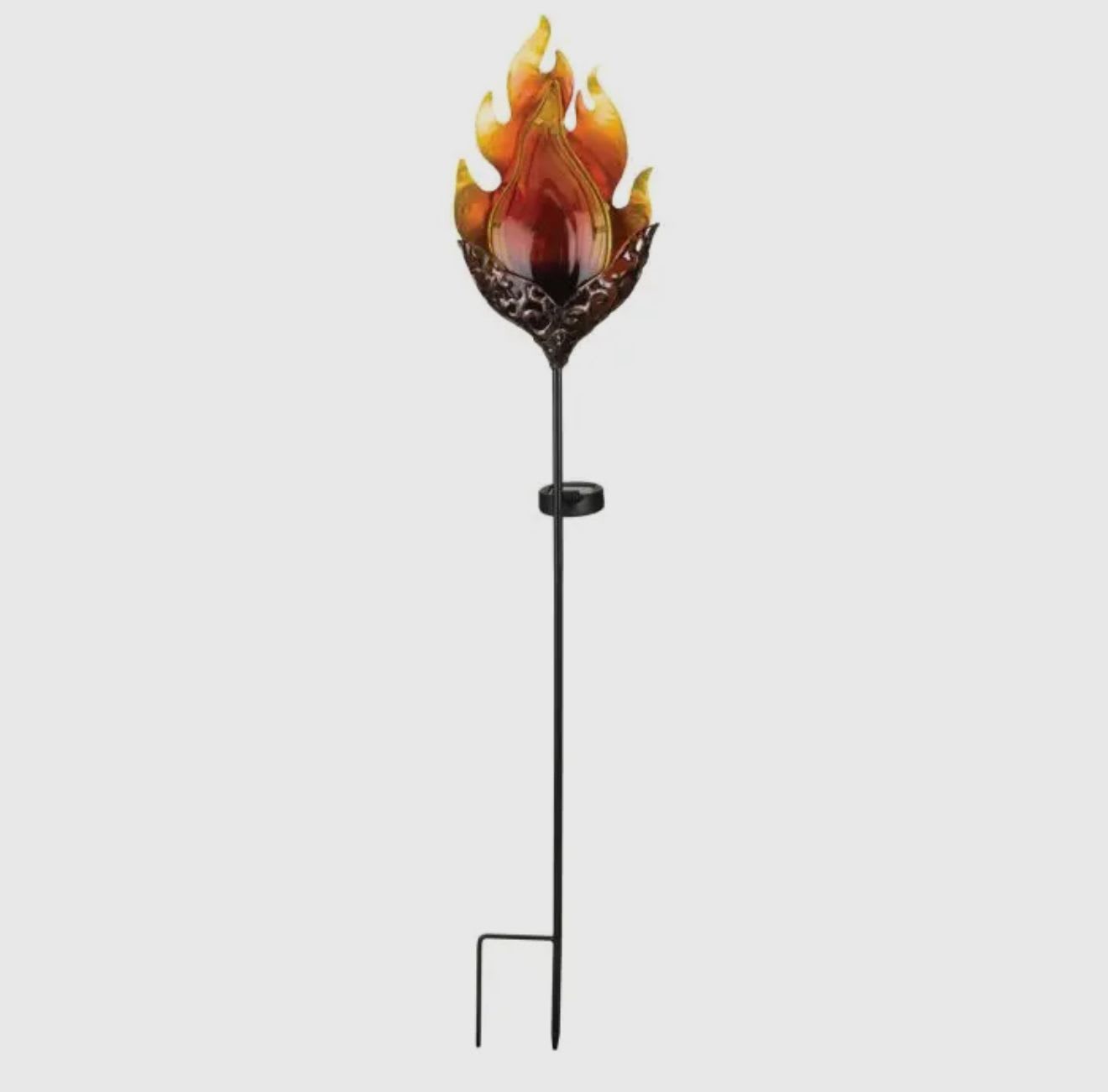 Decorative flame-shaped glass topper on a tall black metal stake