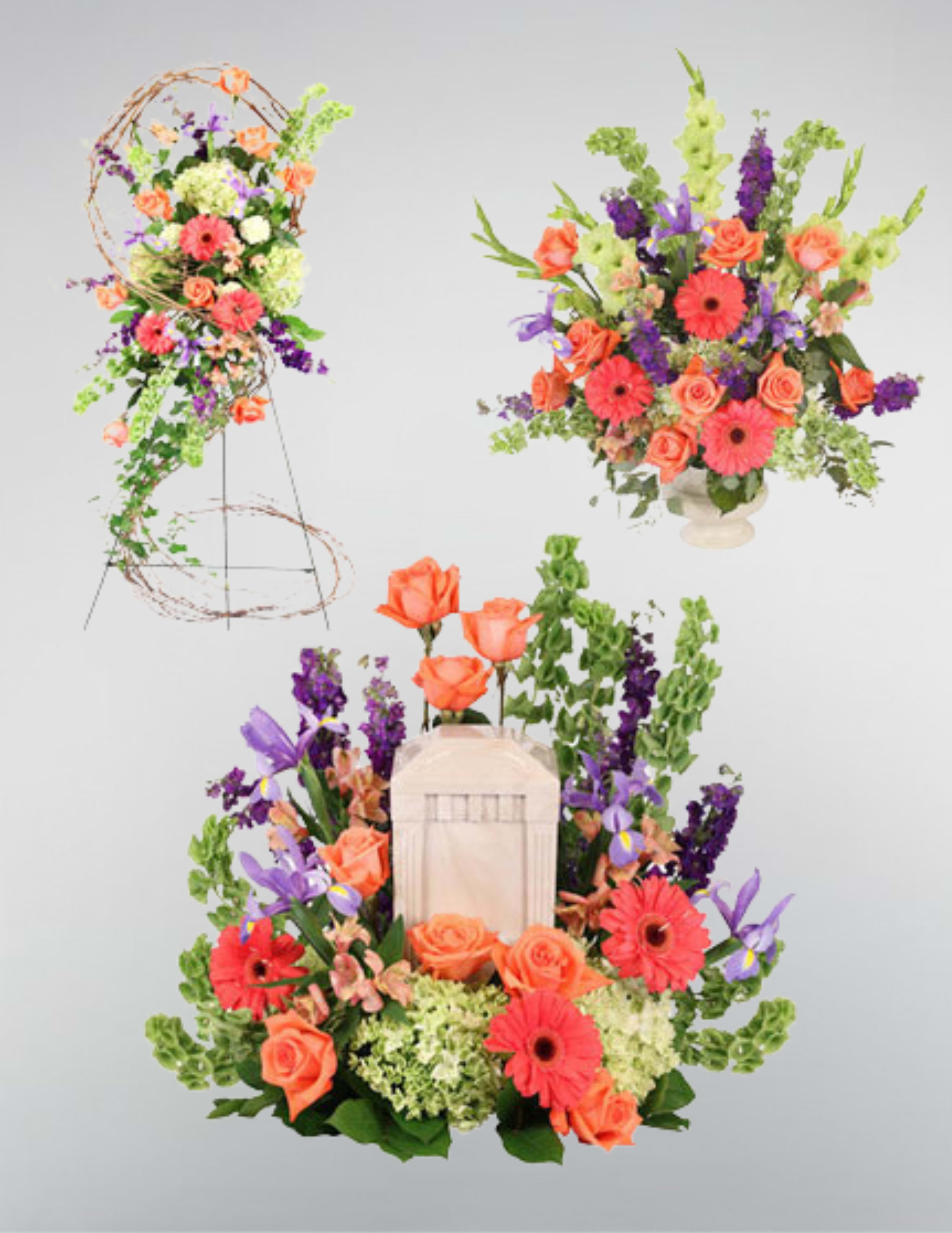 Bright floral arrangement with orange roses, pink gerberas, and purple blooms