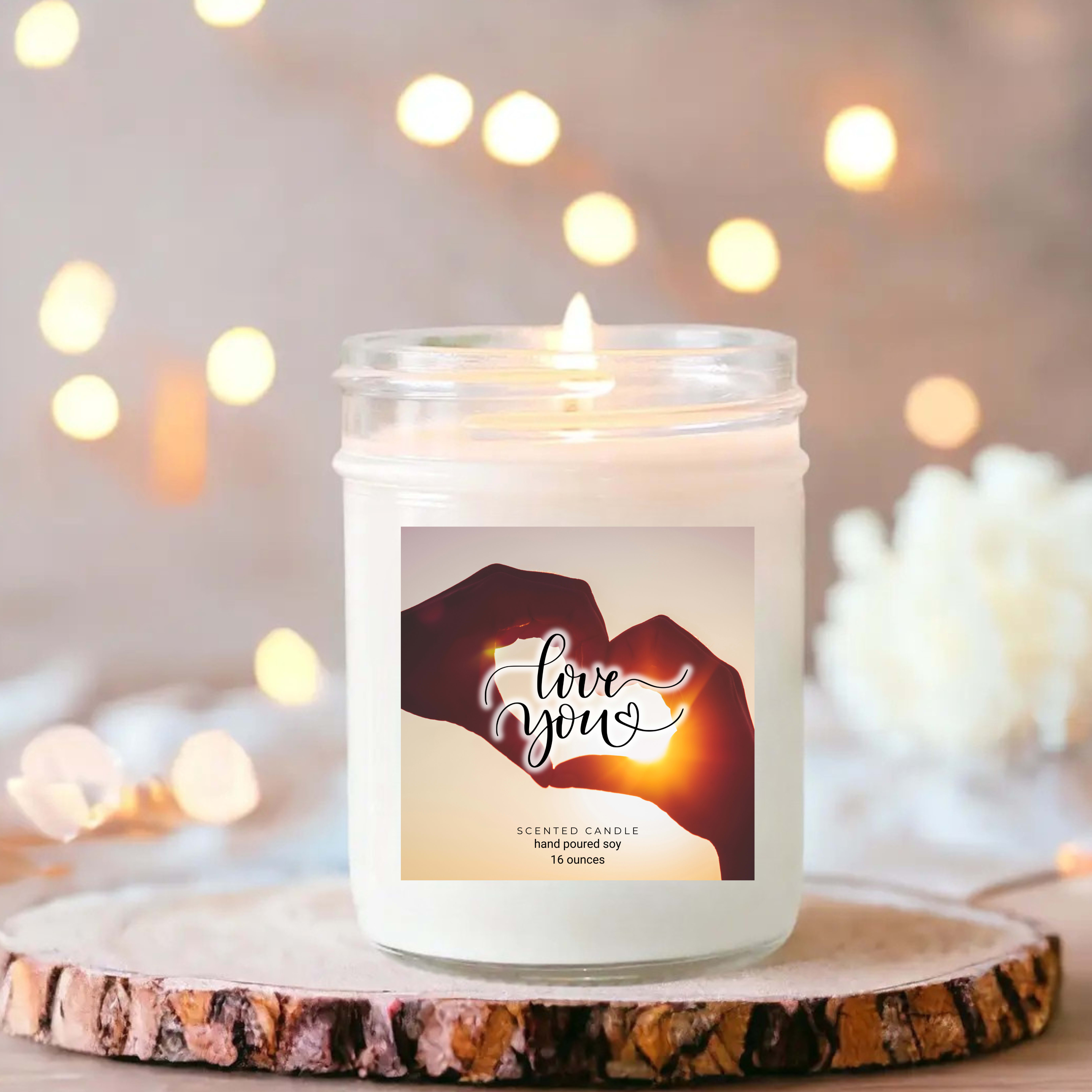 White jar candle with a "love you" label on a wood slice