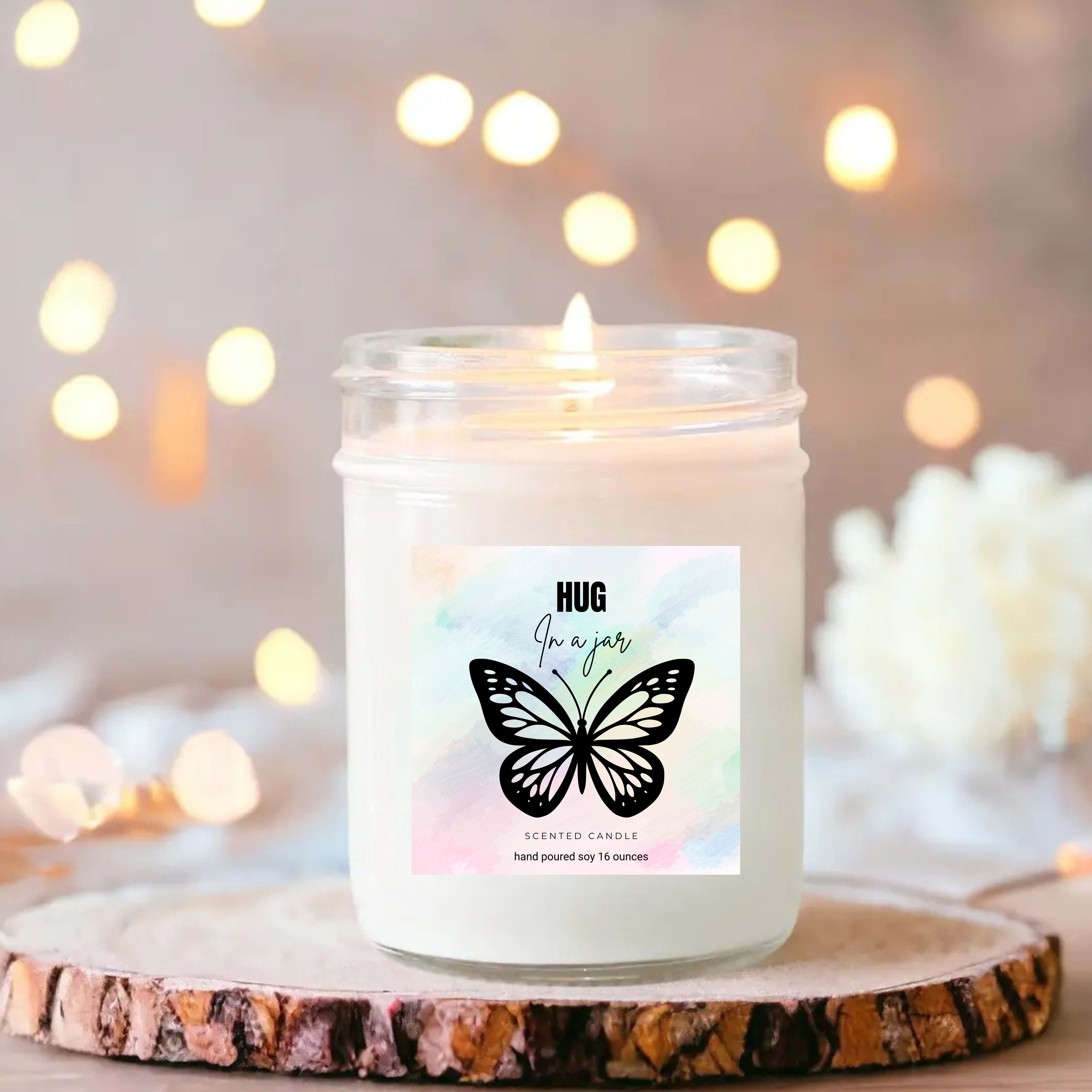 Lit scented candle in a glass jar with a butterfly label