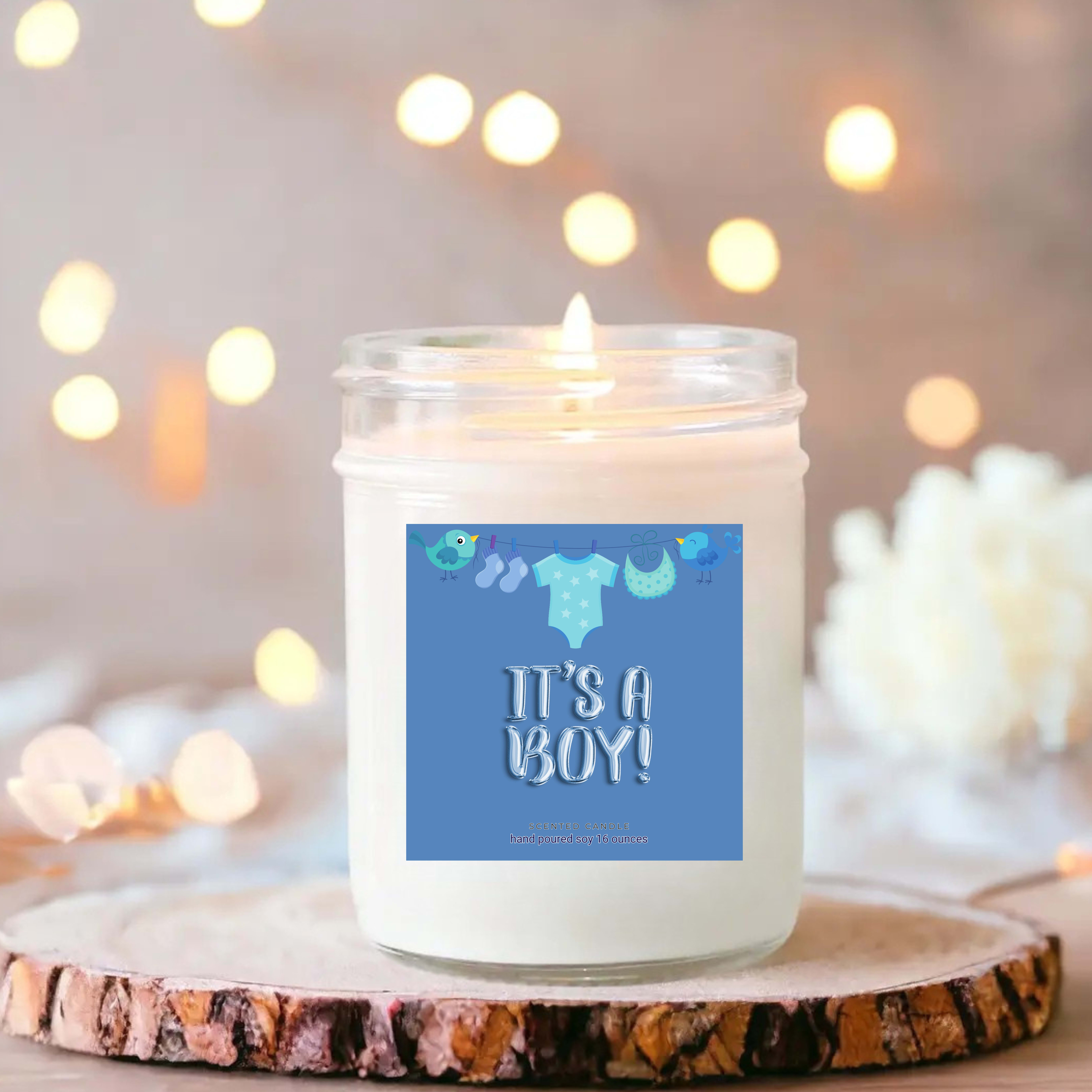 White candle in a glass jar with a blue "It's a Boy!" label