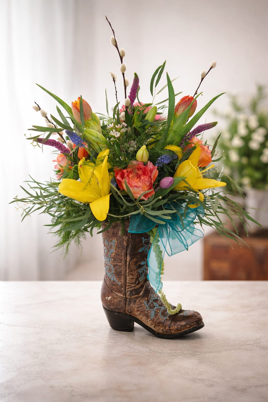 Colorful flower arrangement in a decorative cowboy boot vase