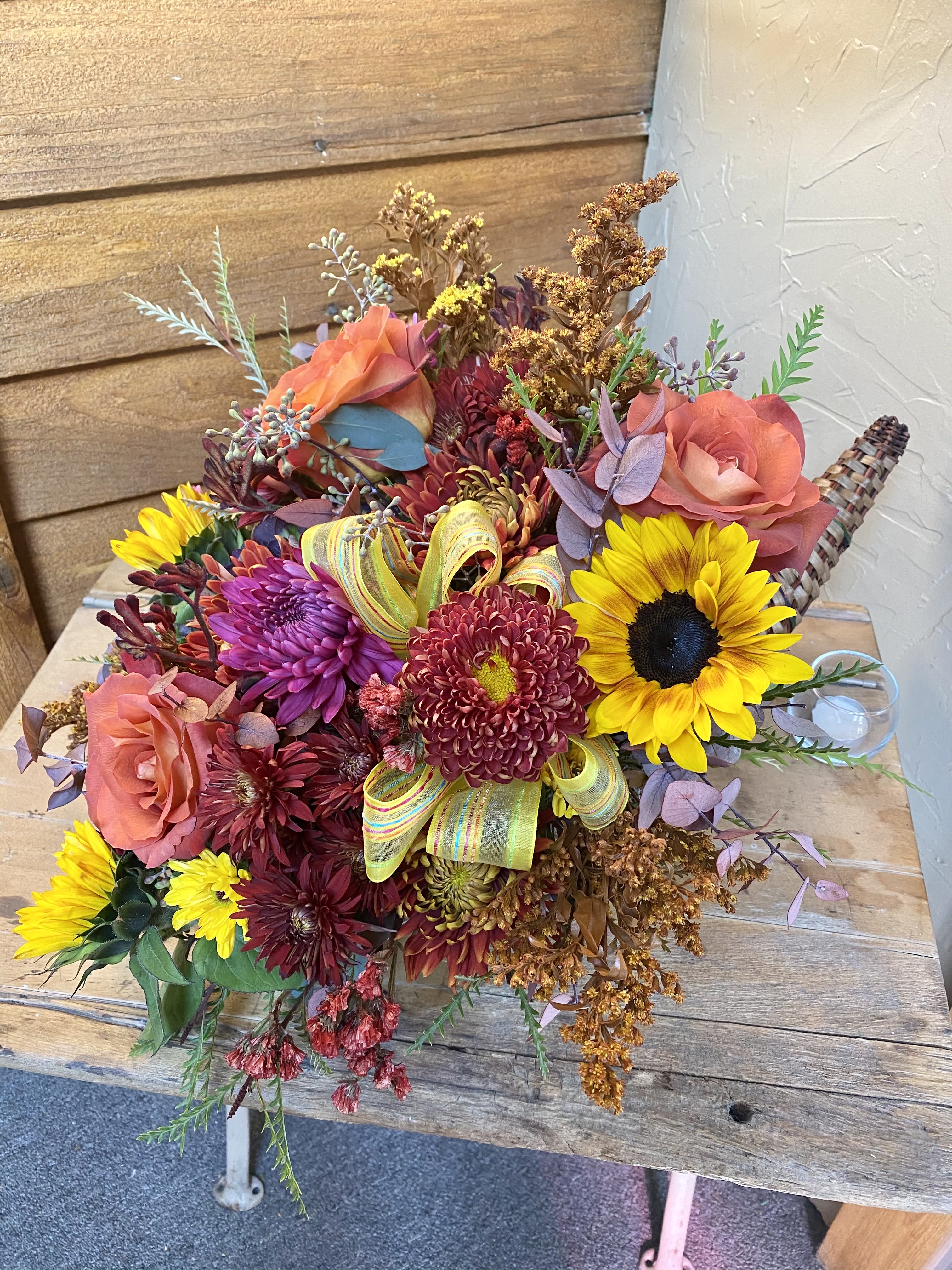 Bouquet of sunflowers, roses, and chrysanthemums with a ribbon accent