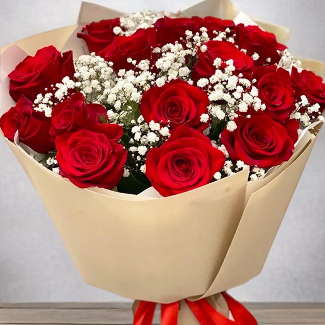 Bouquet of red roses with white baby's breath in beige wrapping