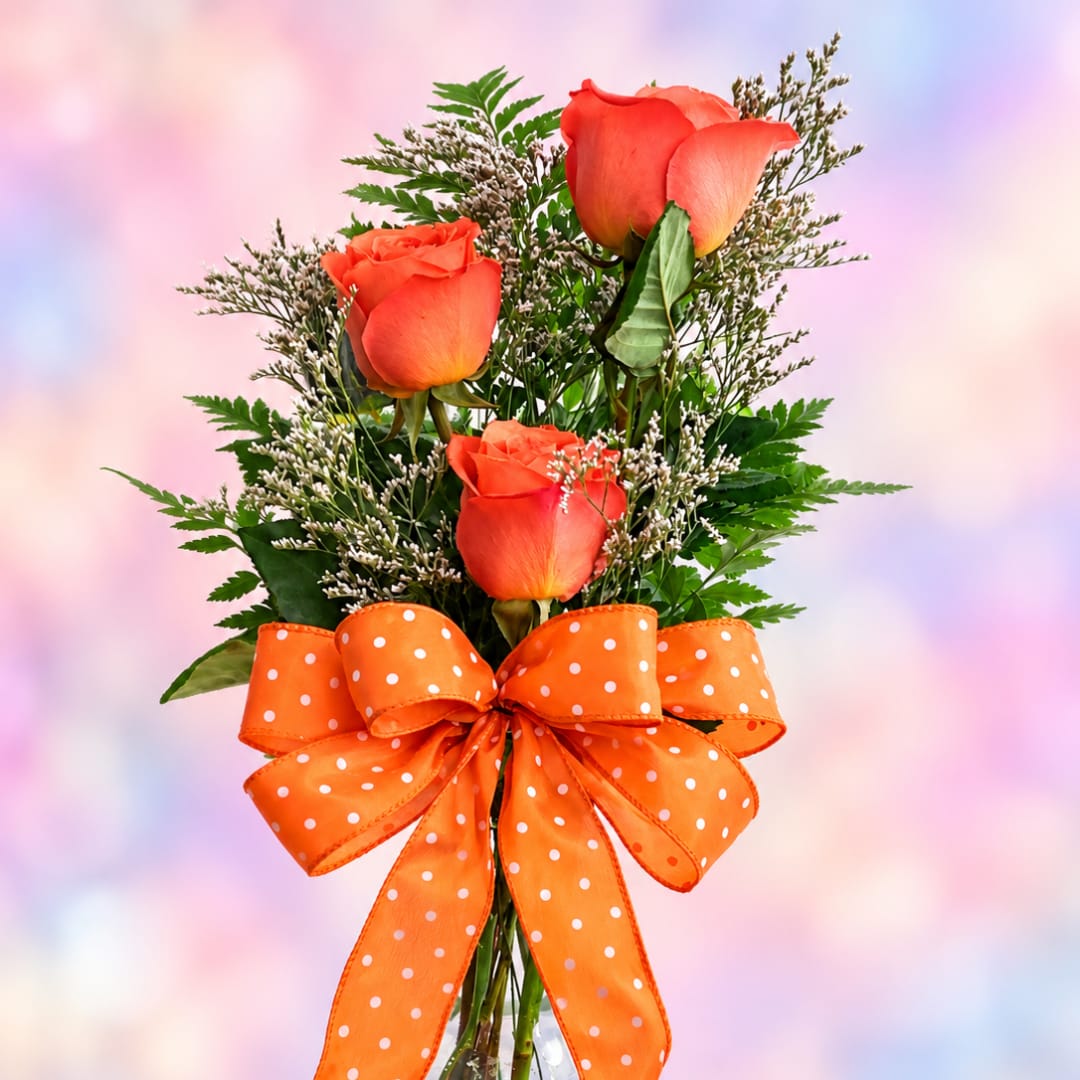 Orange roses with a polka-dot ribbon bow