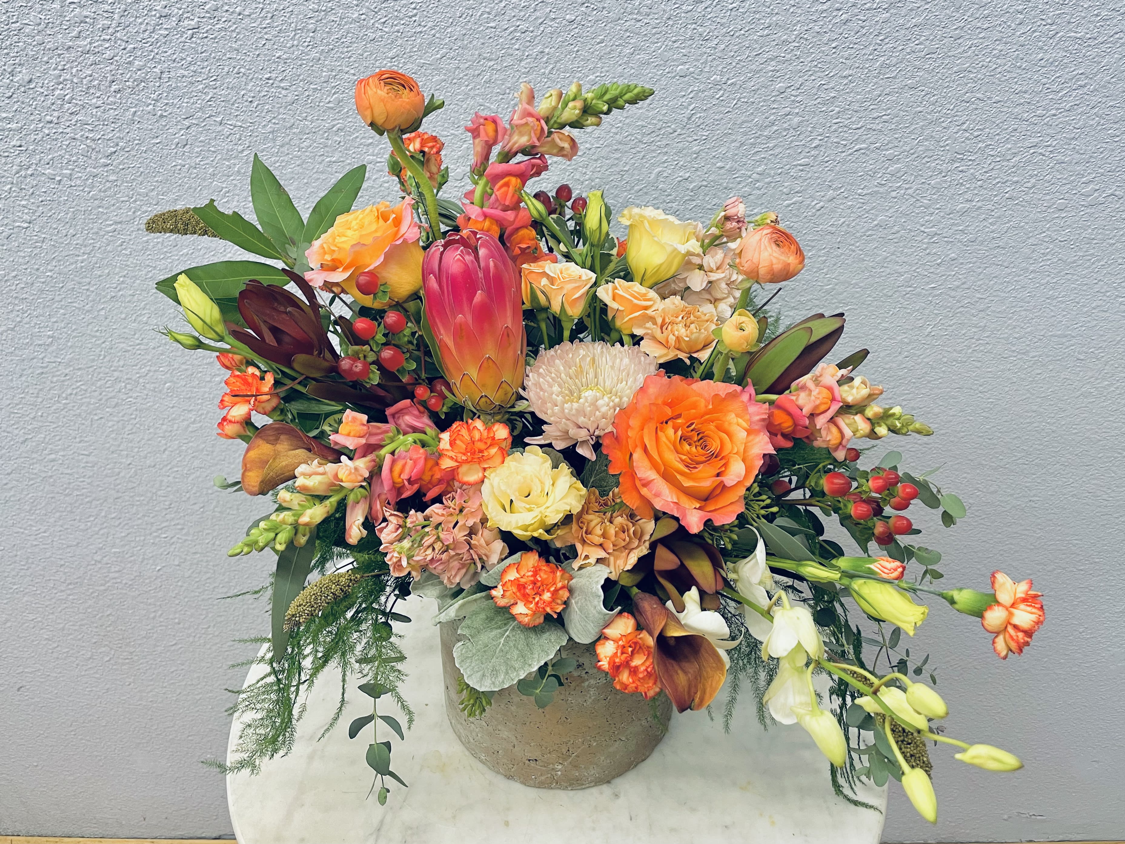 Colorful mixed flower arrangement in a round vase