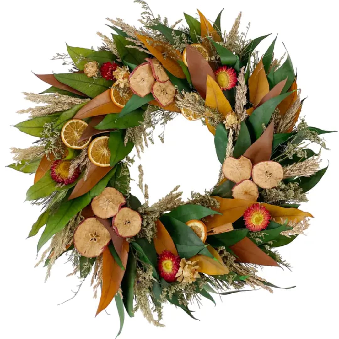 Autumn wreath with dried flowers, leaves, and orange slices