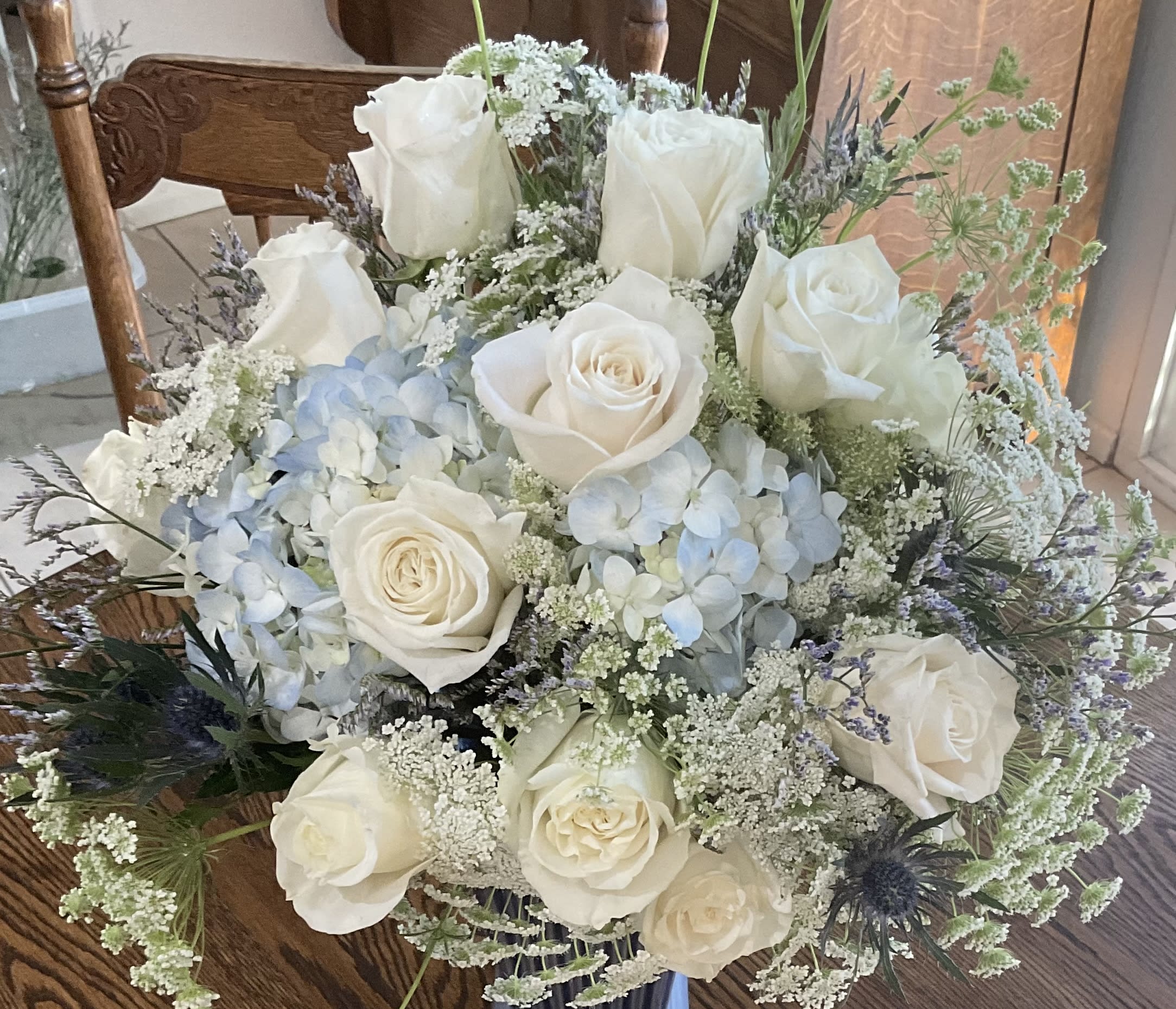 White roses and pale blue hydrangeas in a bouquet