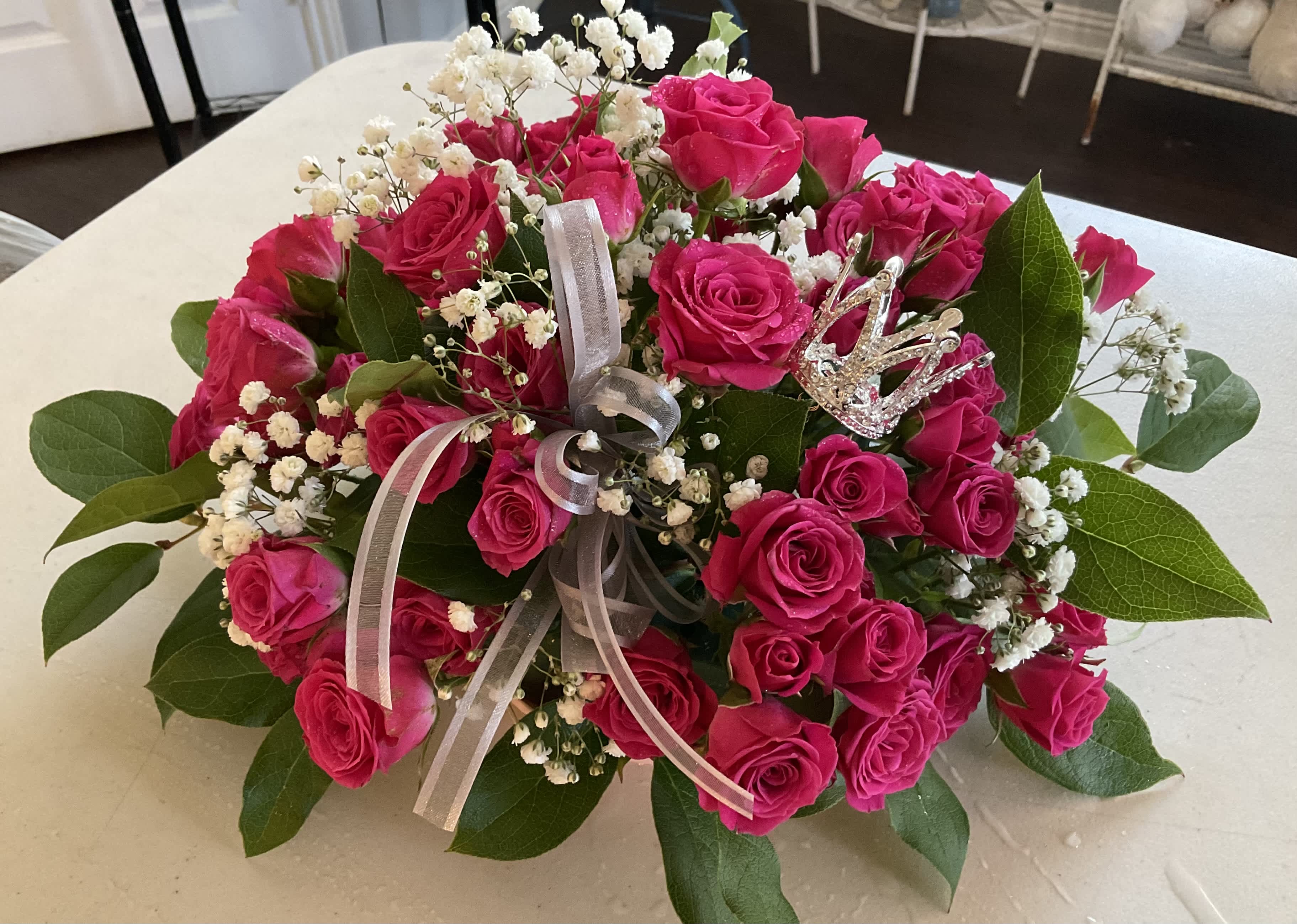 Bouquet of hot pink roses with baby's breath and a ribbon bow