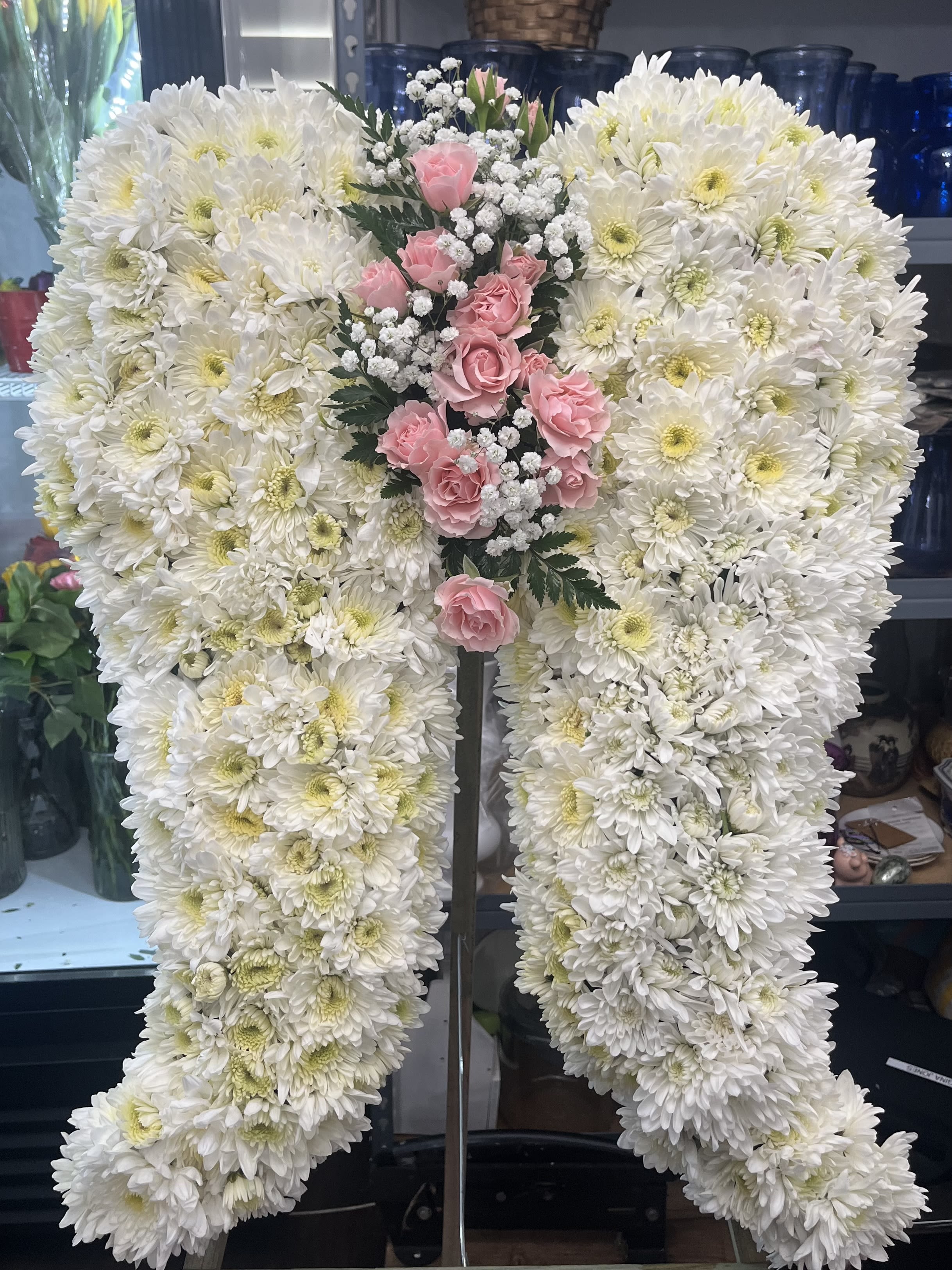 White chrysanthemum standing spray with pink roses and baby's breath
