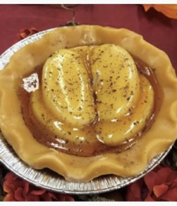 Foil pan holding a yellow molded dessert with a glossy topping