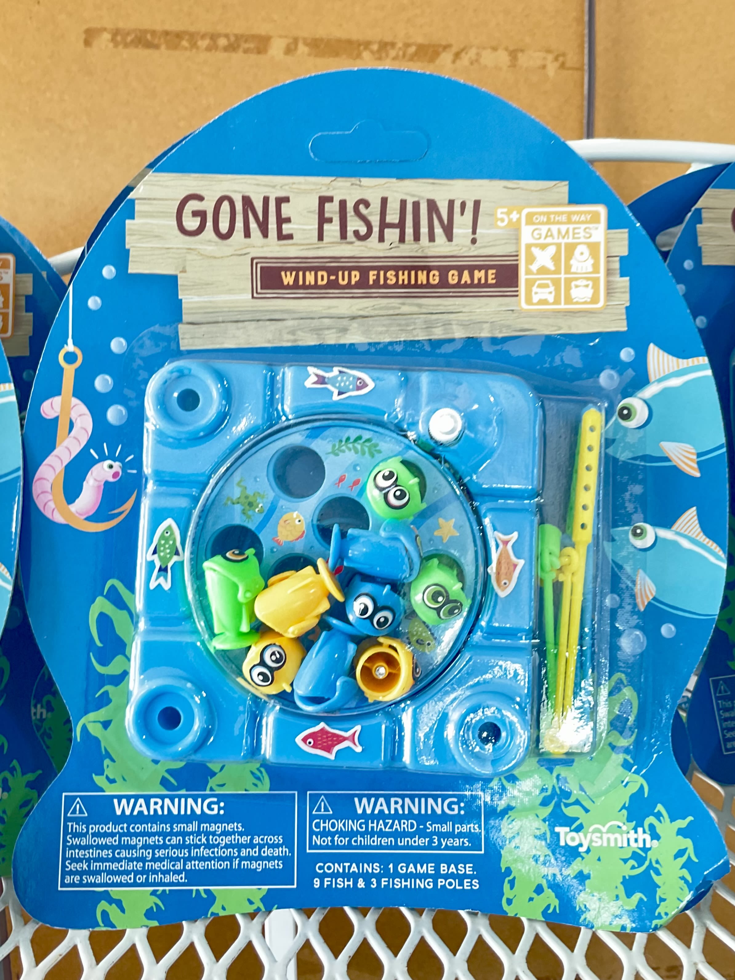 Packaged wind-up fishing game with colorful fish and poles