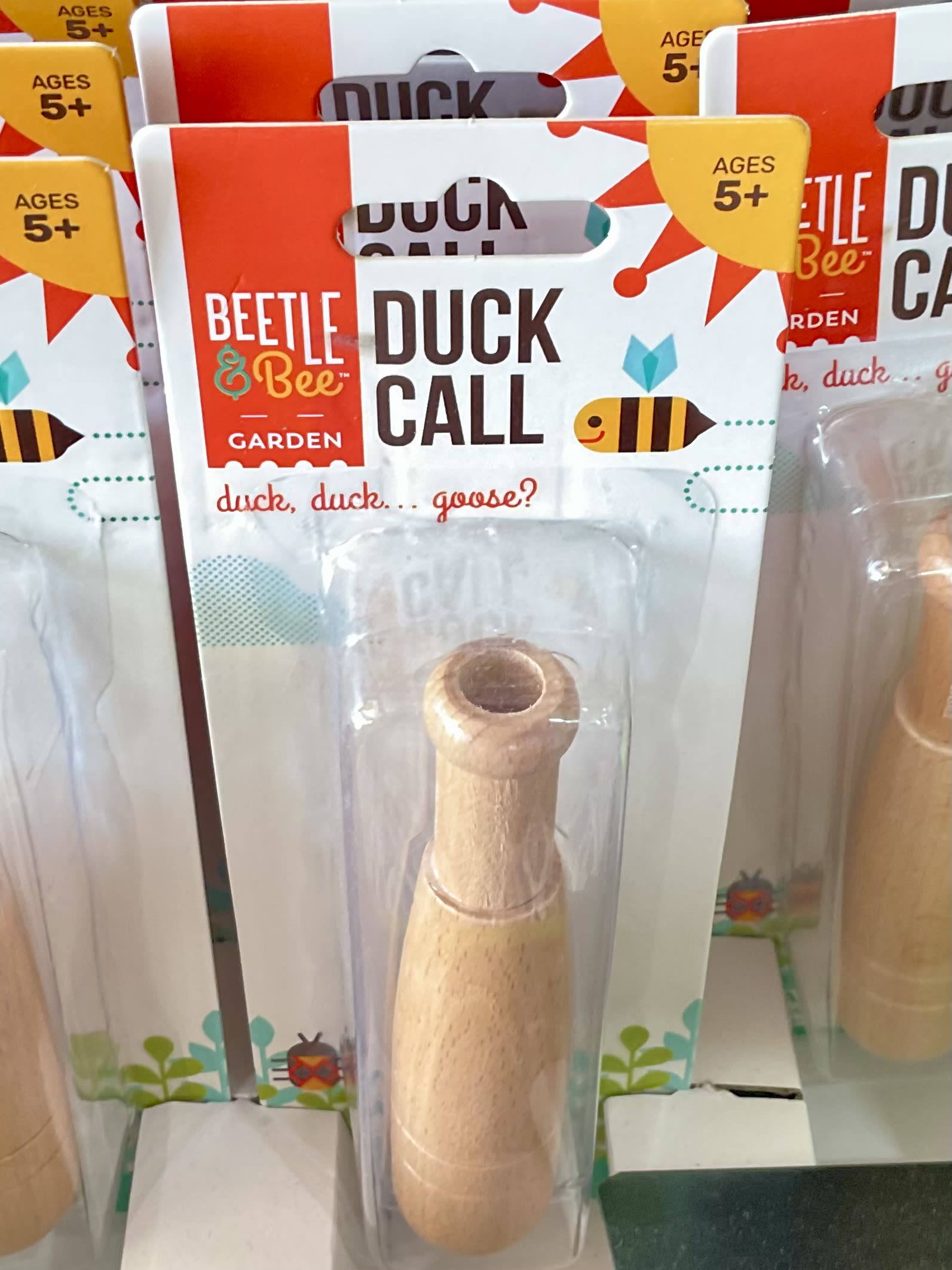 Packaged wooden duck call toy with Beetle &amp; Bee Garden branding