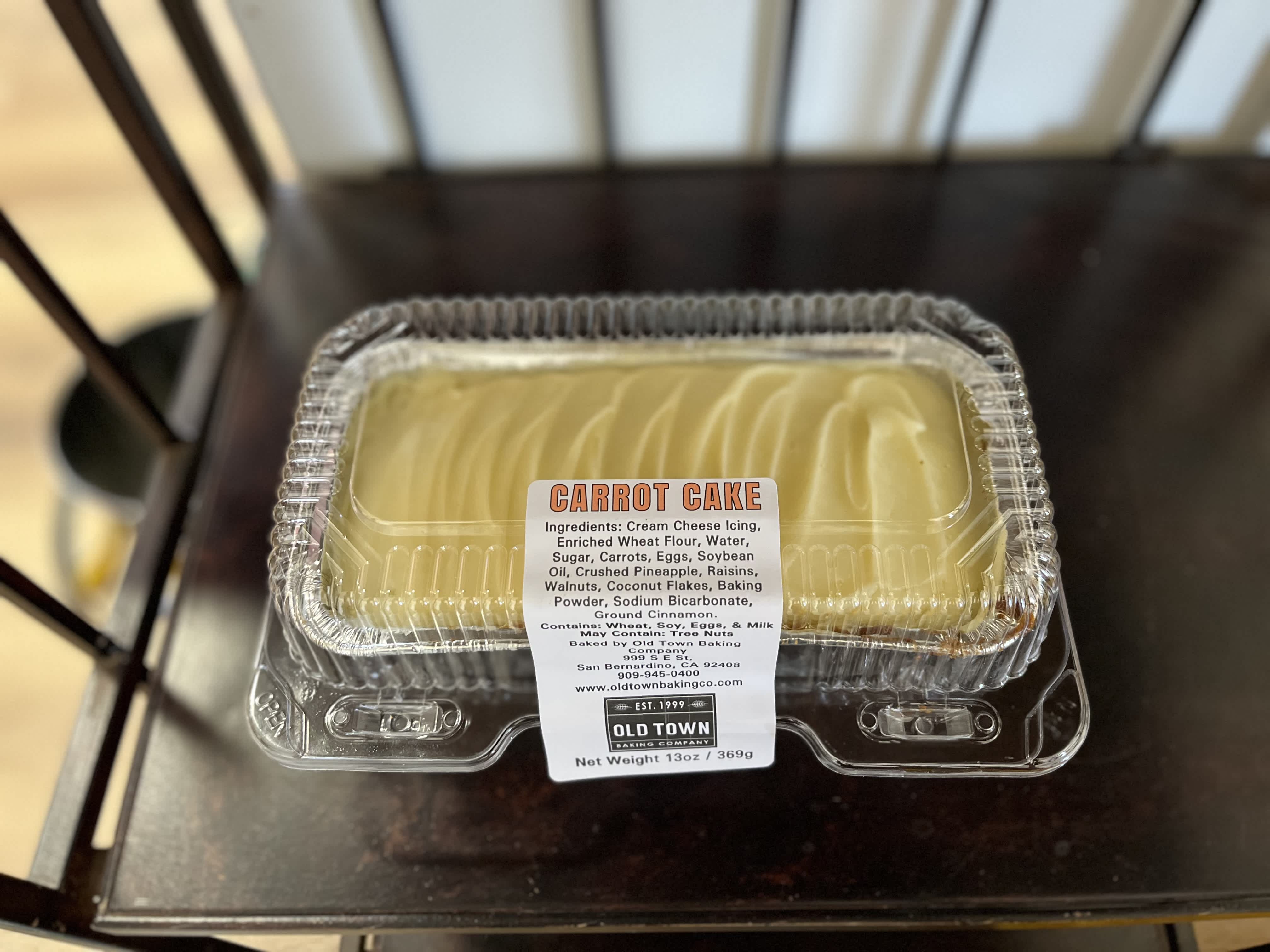 Carrot cake in a clear plastic clamshell container