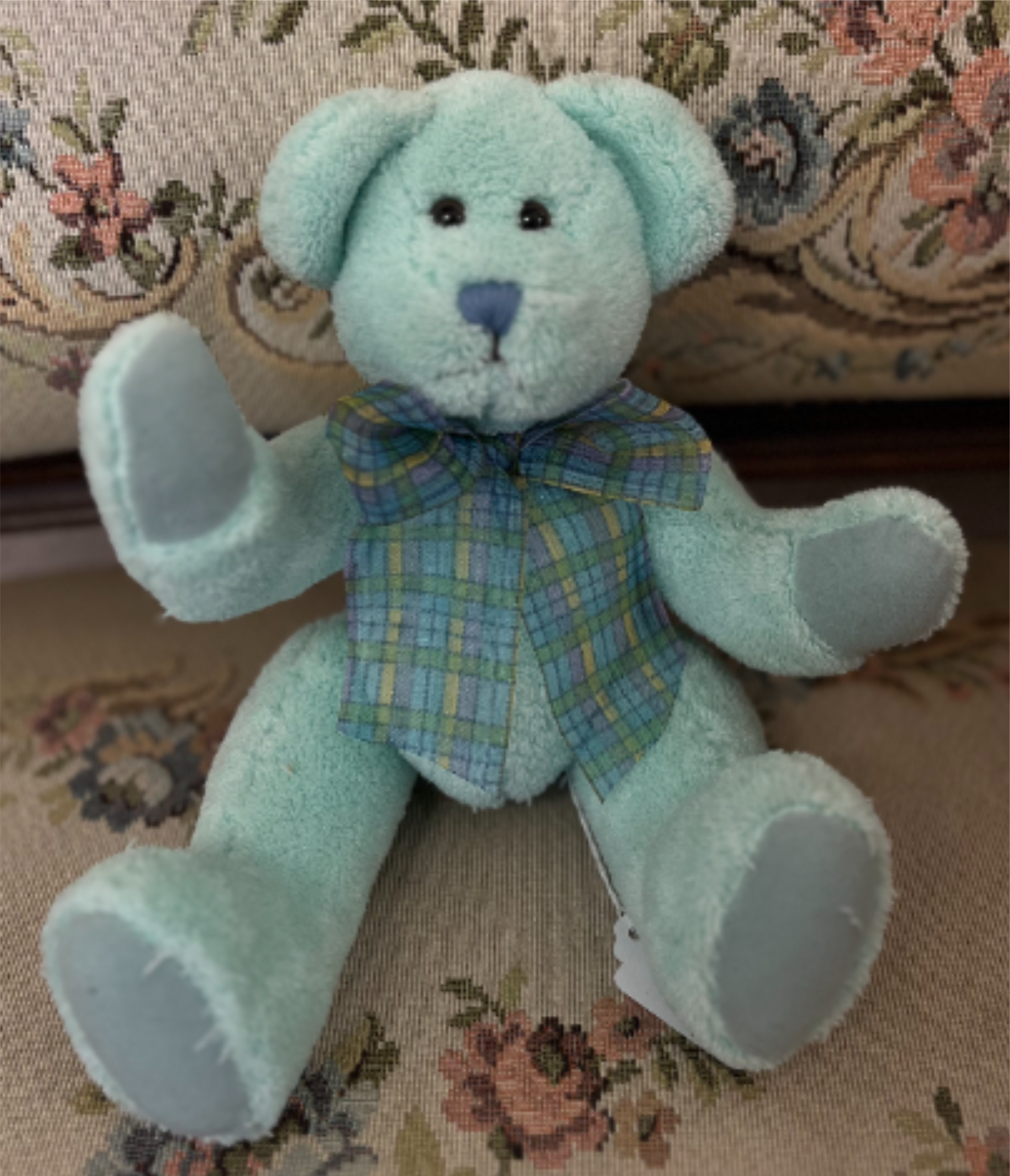 Blue Bear Plush - A soft light-blue teddy bear in a plaid shirt makes a gentle, playful gift perfect for a baby shower, birthday, or "just because" surprise. Sized as a small keepsake, it's an ideal add-on to a bouquet or a standalone gift for a child, new parent, or anyone who appreciates a sweet, tactile present.