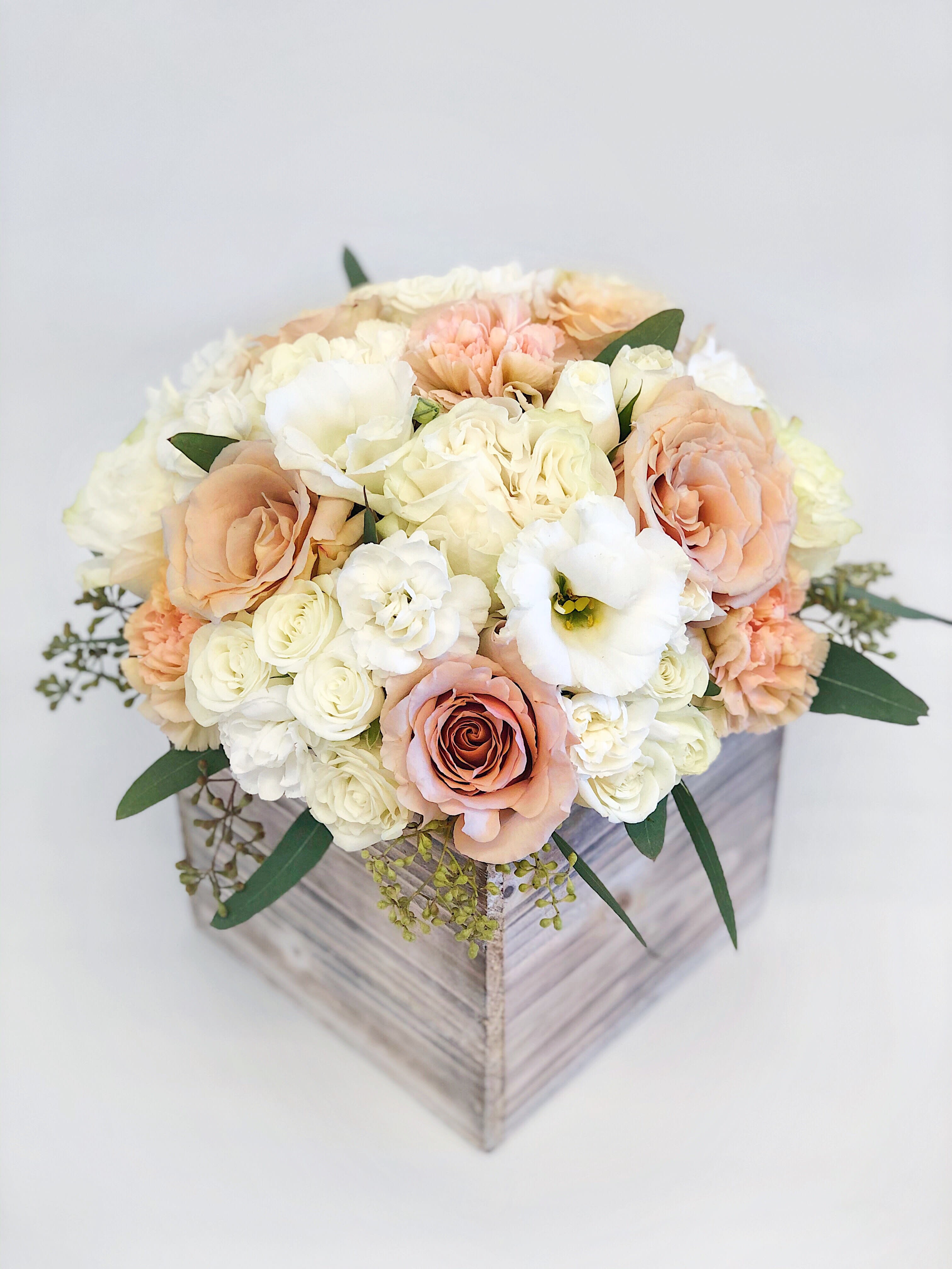 #94 - Large Wood box arrangement peach and white colors  - If You want a bouquet with a twist, choose our flower boxes. We have wood boxes for rustic looking arrangements, or hat boxes for a more elegant look. It’s a beautiful and convenient way. Flowers in boxes don’t need vases. That makes it perfect for transportation and keeping flowers hydrated and secure.