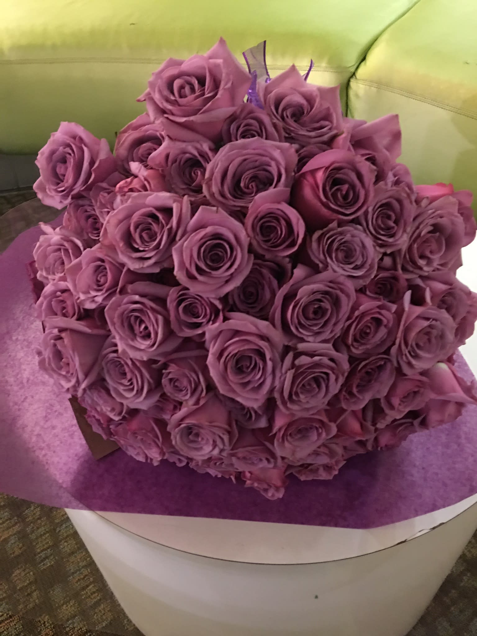Bouquet of purple roses wrapped in purple paper