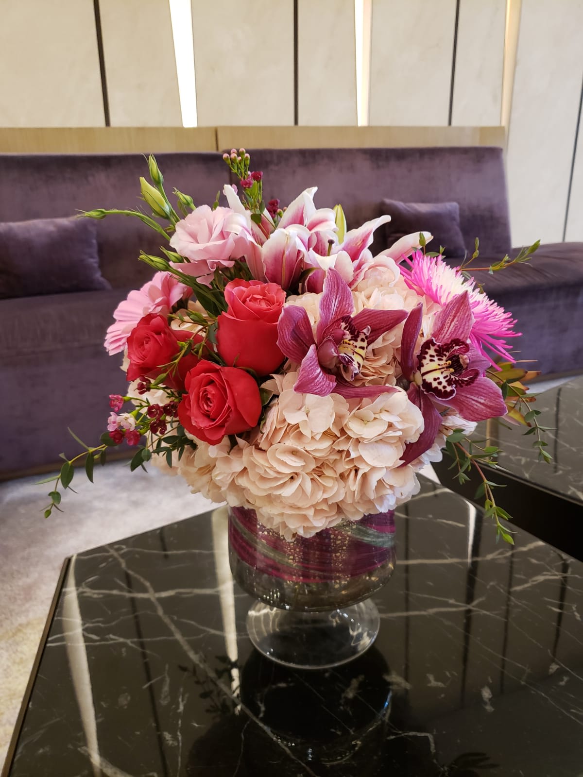 Pink and red floral arrangement in a glass vase