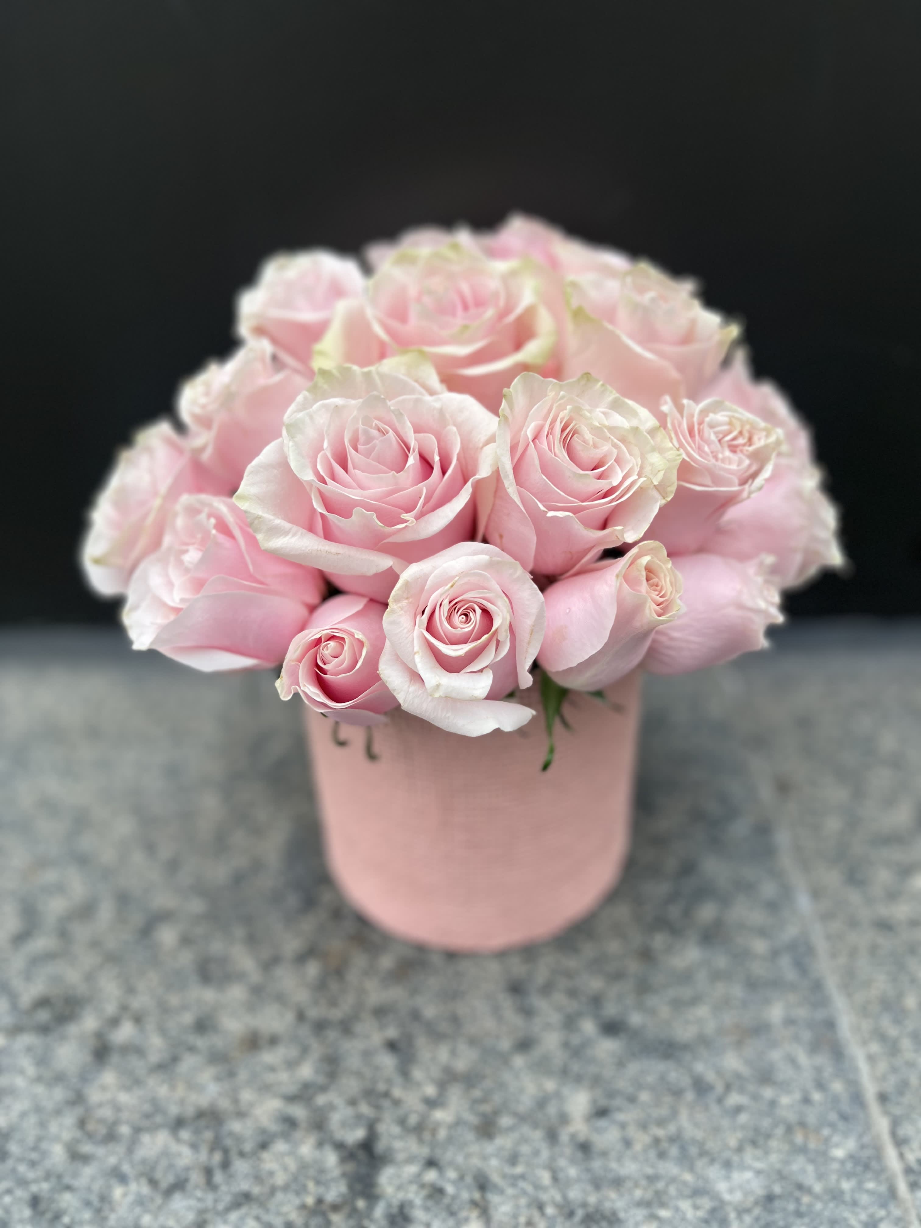 Pink roses arranged in a blush pink box