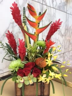 Tropical floral arrangement with red roses and orange bird-of-paradise blooms