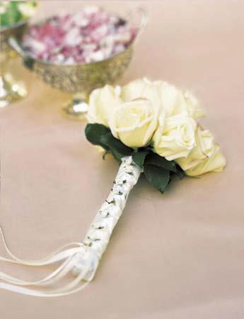 White rose boutonniere with ribbon-wrapped stem
