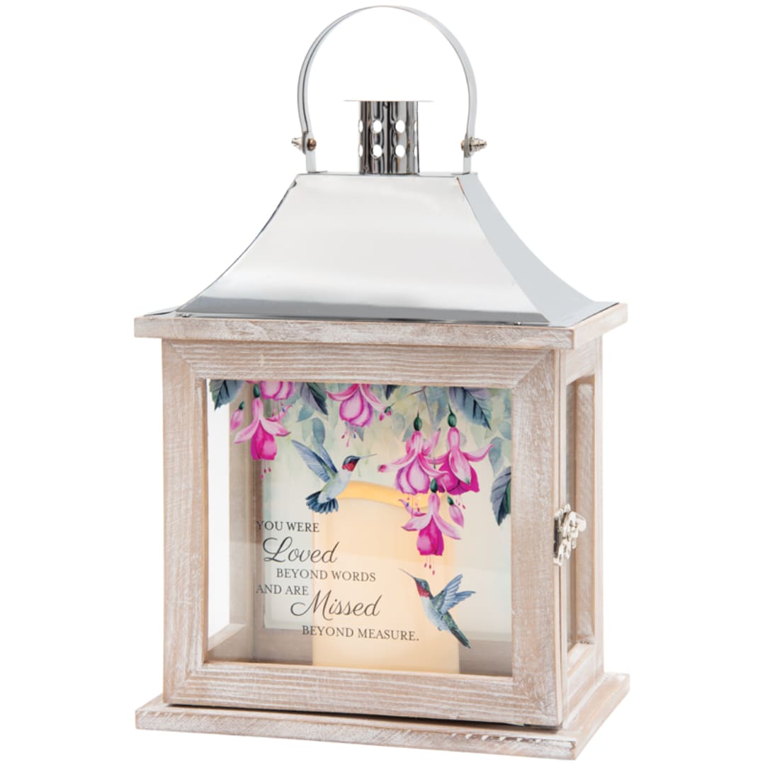 Wooden lantern with a candle and floral hummingbird print inside