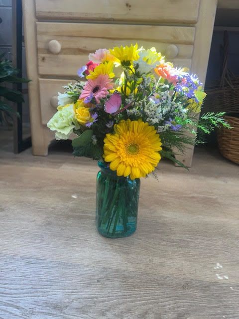 Colorful mixed bouquet in a blue glass vase